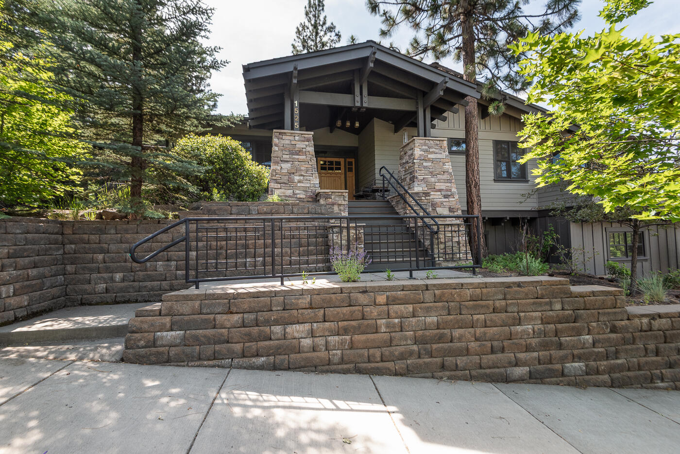 Quality-built Craftsman home by Meloling Construction on a spacious corner lot in desirable Northwest Crossing. This well-maintained home offers all main-level living with an open floor plan, vaulted ceilings, wide hallways, and a gas fireplace in the great room with built-ins. The open kitchen features a large island with Silestone counters, alder cabinets, perfect for entertaining. The primary suite includes a bright walk-in closet, a luxurious tiled walk-in shower, soaking tub, and private balcony. Enjoy exceptional craftsmanship with solid wood doors, Sierra Pacific wood windows with full clear alder wrap, and custom finishes throughout including beautiful stacked stone pillars on the covered front porch. Downstairs, an oversized 3-car garage includes a half bath and additional storage. This home combines timeless design, quality materials, and thoughtful layout in a prime location close to parks, trails, and shops. A rare find in one of Bend's most sought-after neighborhoods!