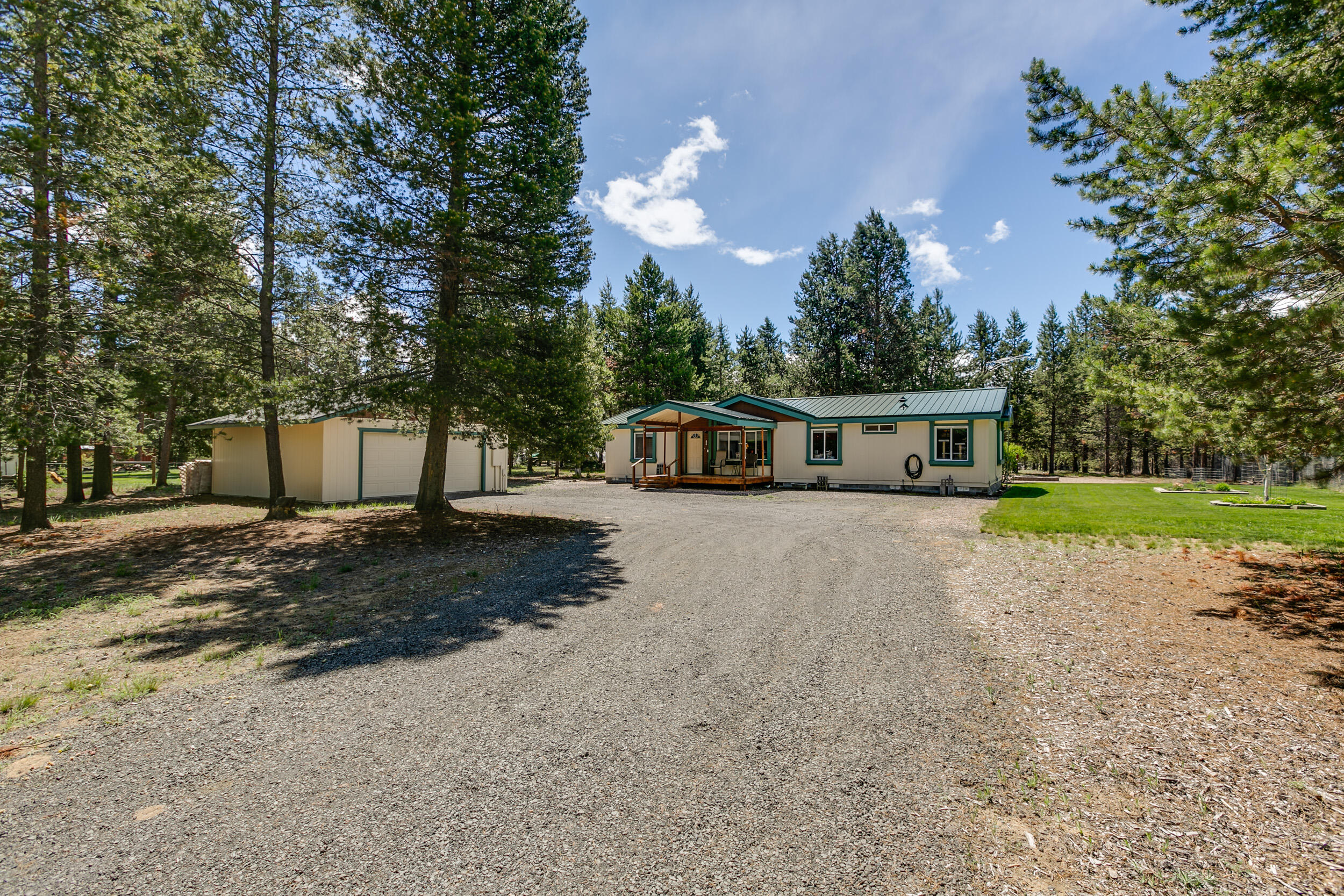 This charming 3 bedroom 2 bath home sits on a picturesque 1 acre lot, offering plenty of space for outdoor activities and enjoying the peace and quiet of country living. Primary bedroom separation from other 2 bedrooms with a great room and separate living room providing the perfect layout for entertaining guests or spending quality time with family with just over 1500 sq ft plenty of room for relaxation and comfort.. A nice functional kitchen with a walk-in pantry, newer dishwasher, hot water heater and blinds. Enjoy the the serene views outdoors from your front or back deck. A nice green lawn in the back of the home invites the squirrels and deer. The back yard is fuily fenced. There is a detached 2 car garage close to the front door an added bonus. This home offers the ideal balance of tranquility and comfort for those seeking a peaceful country lifestyle.