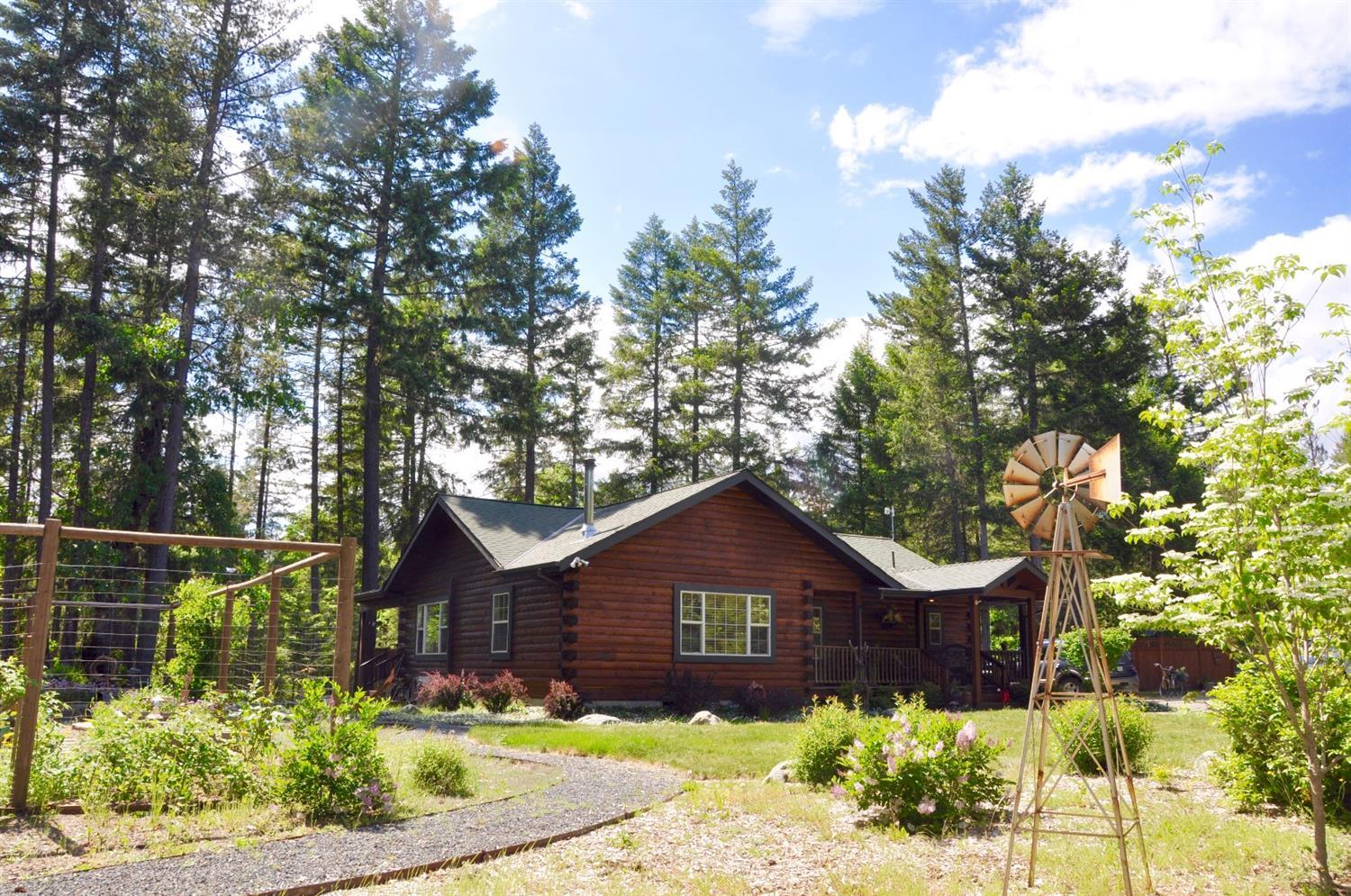 11+ acres of horse lover's bliss with groomed trails around the completely fenced property. The charming 3 bed/2 bath, log sided home with vaulted ceilings has stone & wood floors, custom cabinets & island in the country kitchen, wood stove, open floorpan with french doors leading to the covered deck overlooking paddocks and forest. Wonderful barn with large stalls, wash rack, tack room, & utility room. Covered 40 x 60' arena with sand footing. Chicken coop & additional animal stalls, screened-in dining cottage overlooking the pond, plus more groomed trails thru the forest. Detached, finished shop with RV site & full hook-ups, and artist studio that can double as a guest cottage. This lovely property is great for horse enthusiasts or anyone wanting a private woodland retreat on a quiet country road in Selma, close to shopping and 20 miles to Three Rivers Hospital. Less than $1800 per year property taxes with WR zoning!