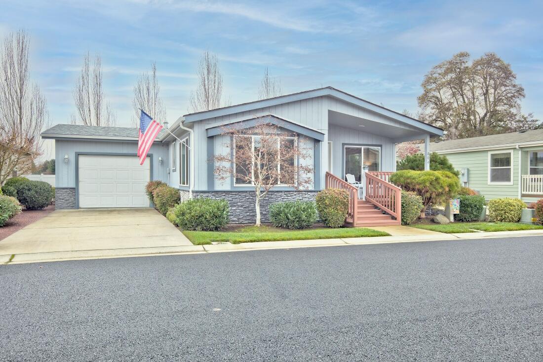 Beautiful, well maintained manufactured home in Westlake Village, the premier 55+ manufactured home park in the Grants Pass area. Not the typical manufactured home. You can't tell it is a manufactured home by looking at it. This is a 1440 Sq Ft, doublewide manufactured home with 2 bedrooms, 2 baths plus a den/office. Built in 2013. Easily maintained landscaping, with a covered patio on back of home and a comfortable, covered front porch.  The home has vaulted ceilings, a large pantry in the kitchen and an oversized single garage. The gas range, refrigerator, dishwasher, microwave, washer, and dryer are included.  Westlake village has a lake and recreation center. Close to downtown and Reinhard Volunteer Park. Seller offers $3,500 carpet allowance at close of escrow,