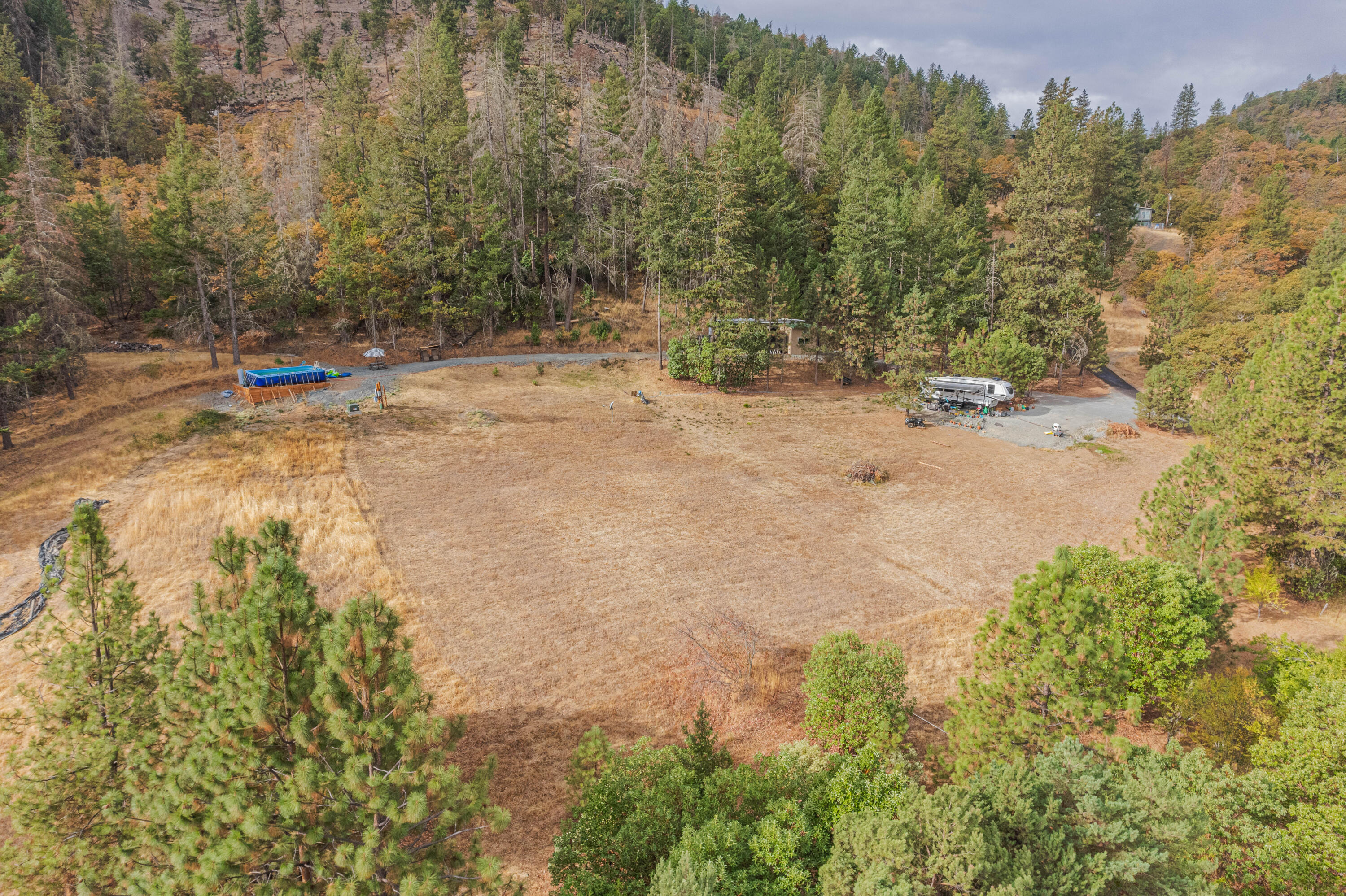 Discover the perfect canvas for your generational dream home! This expansive 14.55 acre parcel offers unparalleled potential with key infrastructure already in place. Utilities, an 18 GPM well, and a 2022 septic system are already installed, allowing for a seamless building process. RV hookups are in place, creating the perfect scenario to live in while your dream home is being built! There is also an incredibly convenient outbuilding that is equipped with water, electricity and an a/c unit that is currently being used for laundry and storage. Nestled in a peaceful, beautiful setting, this land offers a blend of open spaces and mature trees, providing the perfect balance of privacy and accessibility. Located in rural Medford and just a few minutes from Jacksonville, this versatile property offers endless possibilities, building sites have been approved so bring your creative vision and don't miss out on this amazing opportunity. Schedule your tour today