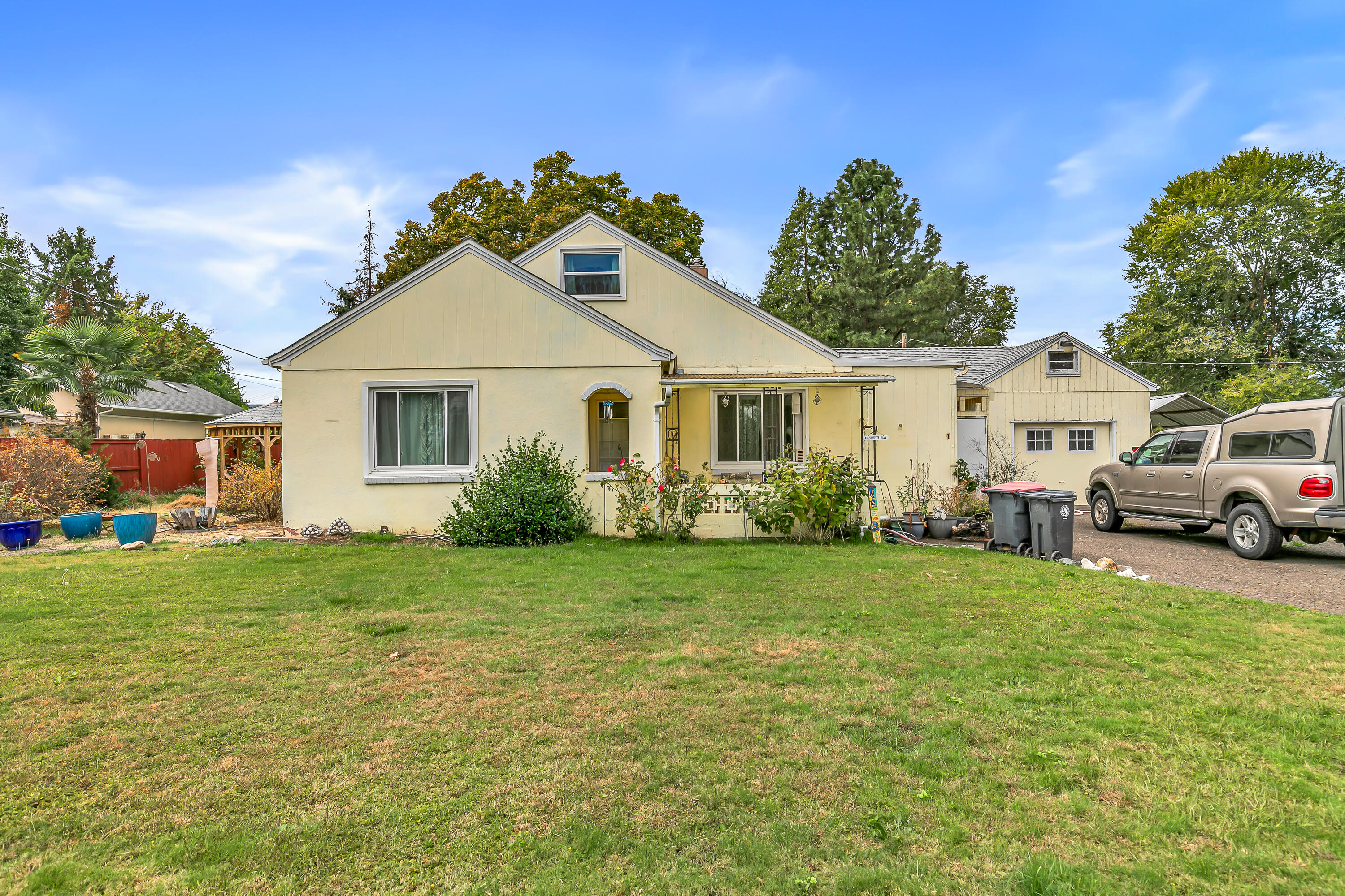 This charming home sits on just under an acre and is packed with potential. The flat, usable land with a newer 15GPM well, is perfect for animals or the garden of your dreams. Outbuildings include a barn with stalls, workshop, garden shed, and a covered carport ideal for your boat or RV. Inside you'll love the flexible floor plan with 2 main-level bedrooms and 3 spacious bedrooms plus a half bath upstairs. Tucked perfectly between Medford and Jacksonville, this location gives you quick access to shopping, dining, and wineries while still feeling like your in the country. Bring your vision and make this versatile property your new homestead!
