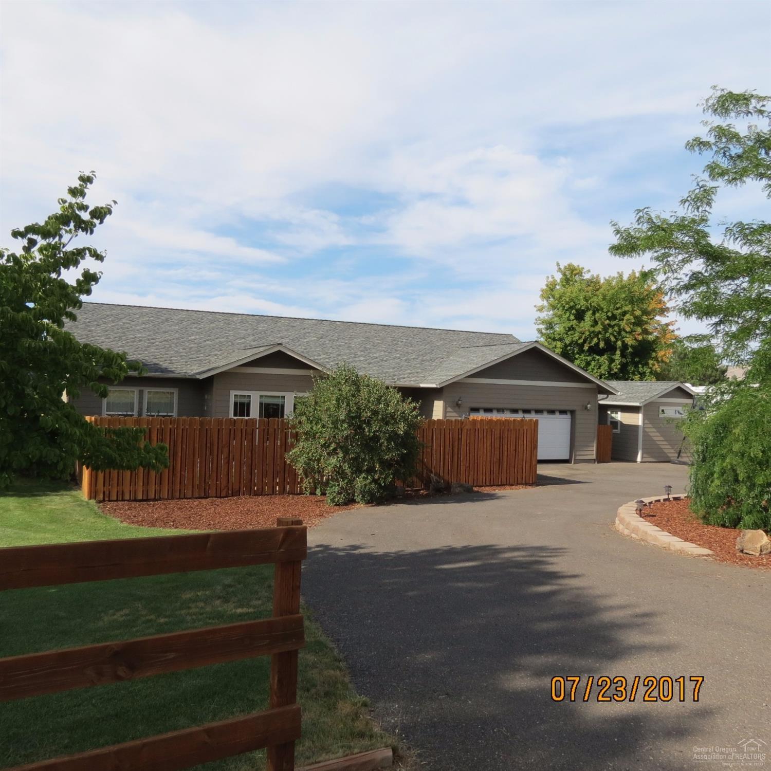 Beautiful single story home on .60 of an acre. Jefferson, Hood, 3-Finger Jack, and Smith Rock Views. This home boasts Tile floors, cheery sun-room with wood floor, a pantry, 2-walk-in closets in master, den, and a propane fireplace. RV PARKING, Fenced, Hardi-plank siding, rain gutters, manicured yard, front & back porch areas, 12x12 newly finished & heated craft/art studio, water feature, and HOT TUB. With a Double Garage, extra insulation in attic and garage. Great Location! Room to build a barn or shop!