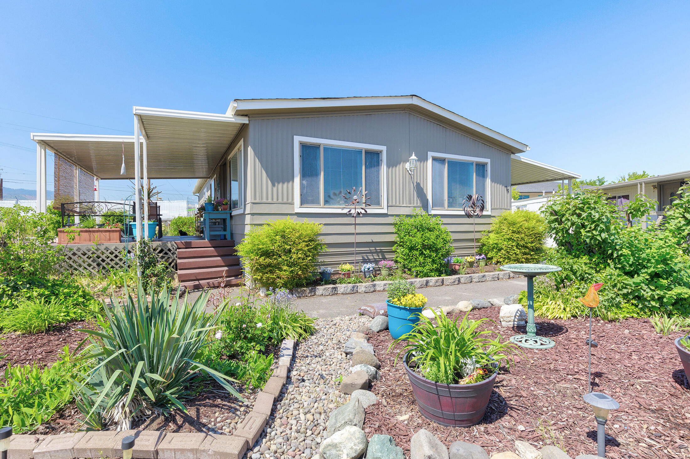 Home is on LARGE corner lot in a family park! This 2 bedroom 2 bath home has many improvements, including in 2020 new roof, new paint inside and out, Samsung appliances, Heat Pump, and an air purifier. In 2023, new duct work, new water heater(40gal), window trim and newer mini blinds and high efficiency toilets. Two sheds on the property with power to them. If that isnt enough, the amount of yard space is very inviting. The new beautiful club house has pool tables, swimming pool, hot tub, gym, playground, meeting space and so much more. Buyer must apply to park and be accepted. Buyer to due their due diligence on park rules and property requirements.
