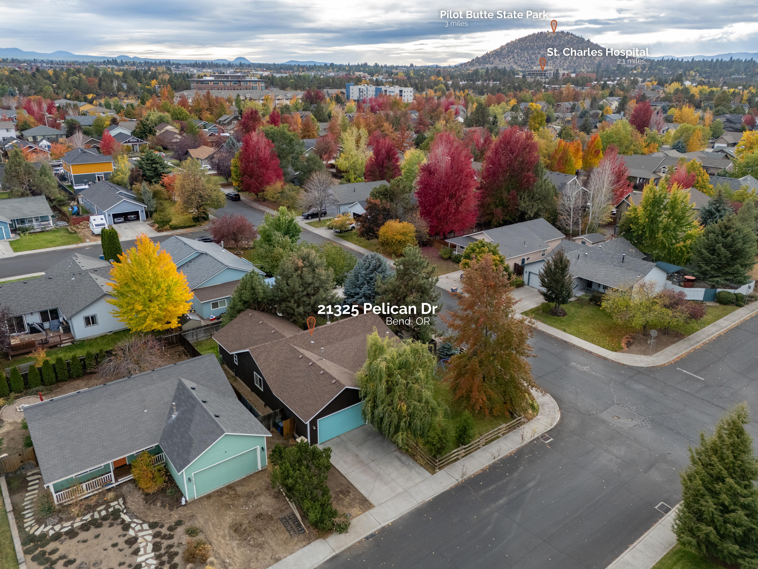 Tucked on a serene corner lot in a desirable neighborhood in NE Bend, this 3-bed, 2-bath home offers privacy, location, & keyhole Mountain Views! A covered front porch & serene front yard w/mature trees leads into a vaulted great room layout adorned w/hardwood flooring throughout the main living area, recessed can lighting, & a cozy wood-burning fireplace. Kitchen ftrs breakfast bar seating, tiled floors + counters, plenty of cabinetry & counterspace, as well as stainless steel appliances. Well sized primary bedroom w/shower+tub combo & walk-in closet. Two addtnl guest rooms share a full bath. Laundry room w/buil-in shelving. Sliding glass doors off the dining area lead to the back deck, paver patio area w/hottub, outdoor shower, greenhouse, chicken coop, & lean-to firewood area. Oversized garage includes built-in storage, plus there's RV parking for your toys. Near Pilot Butte, hospitals, 1.2 miles from On Tap Food Truck Lot, Sunriver Brewing, Whole Foods, & Mountain View Highschool!