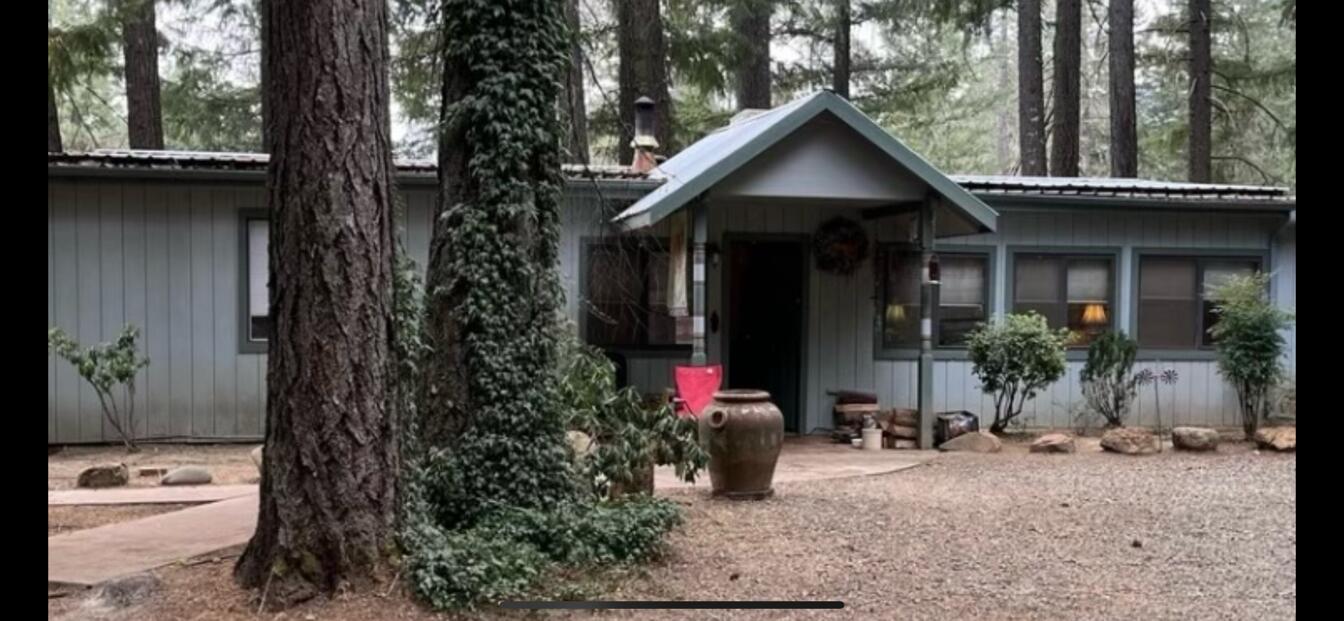 2 Family Set Up in a tranquill forested location. What we have is a 2,015 square foot home with 3 bedrooms and 2 bathrooms. Updates have been made to the bathroom, new forced heat and air in addition to the certiified wood stove, swamp cooler and new cadet wall heater. The main suite has a walk in closet and the kitchen features a gas stove.  The additional dwelling of 920 square feet seems much larger with its niice full kitchen and has 2 bedrooms and 1 nice sized bathroom., with its own power meter and septic. Both homes come with all appliances. This property is fully fenced and has an automatic gate,. The park like grounds offer many fruit trees and there are sprinklers to help you with the watering and its backed by a 15 gallon per minute well, there is also a second well, but not in use. RV space is ready with hook ups and there is a generator for emergency. Lots to offer/