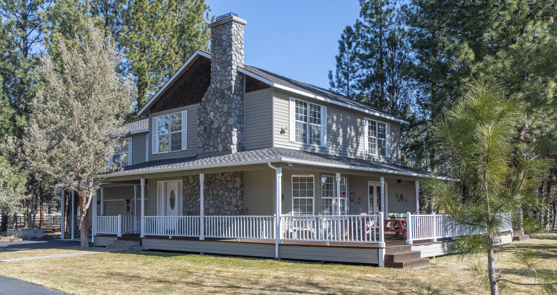 Welcome to Tall Pines located in the prestigious Starr Ranch neighborhood just a few minutes from Sisters, Oregon. This small acreage property with a park like setting, offers an updated 2839 sq ft main house as well as a spacious 1500 sq ft guesthouse with 2 separate sleeping quarters to be used for family, friends or long-term rental. An 864 sq ft Artisans studio or home office space completes this family estate. The main house boasts a modern kitchen, family room with a beautiful river rock fireplace, laundry and 1/2 BA all on the main level.  Upstairs 2 large master suites with exceptional en suite baths & additional family room with a cozy fireplace. The 3rd BR & BA are located in Guest House. The garage is a 4 car, double tandem with work bench & heat. This property has beautiful pines for privacy, is fully fenced and gated with separate pastures in the front and back. From the moment you pass through the gates this amazing farmhouse with a wraparound porch welcomes you HOME