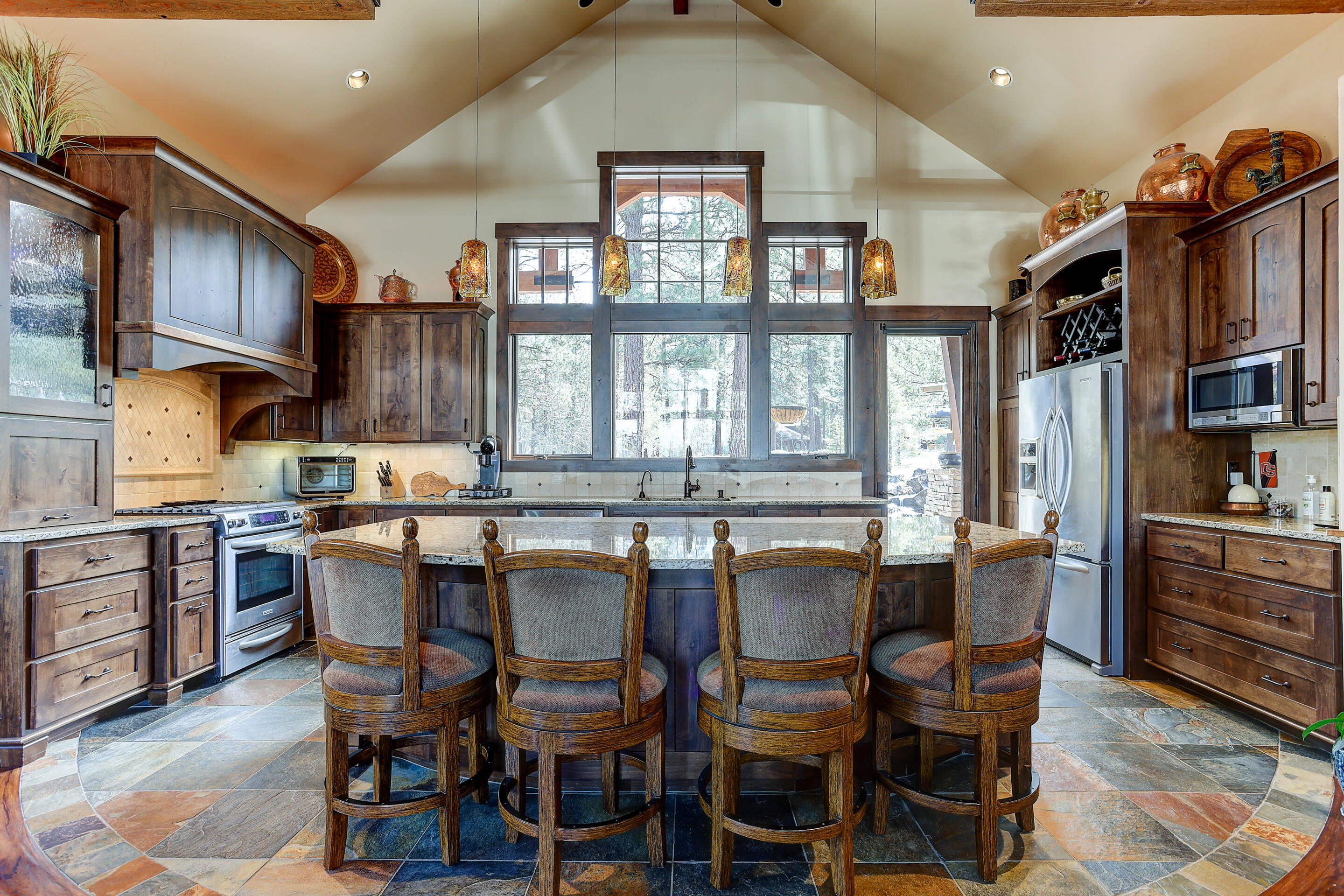 A Beautiful 4 BR, single level custom NW mountain home built by Sun Forest in Caldera Springs, Central Oregon's top rated destination resort community. Take in the mountain views from living room & bedroom, custom light fixtures and thoughtfully designed beam work that parallels the highly appointed Caldera Springs Lake House design. Stunning copper accents throughout the interior & exterior.  A timeless design like no other with no details overlooked in this home.
One of the en-suites has a dedicated private entrance and option to lock off from main home; a spacious, fully equipped guest suite with a full bath, kitchenette and outdoor patio access. Equipped with smart home features, 4-zone heating, motorized blinds and heated bath floors in primary & guest suites and kitchen. Enjoy outdoor living on the covered back patio while taking in the breathtaking forest and water feature views.