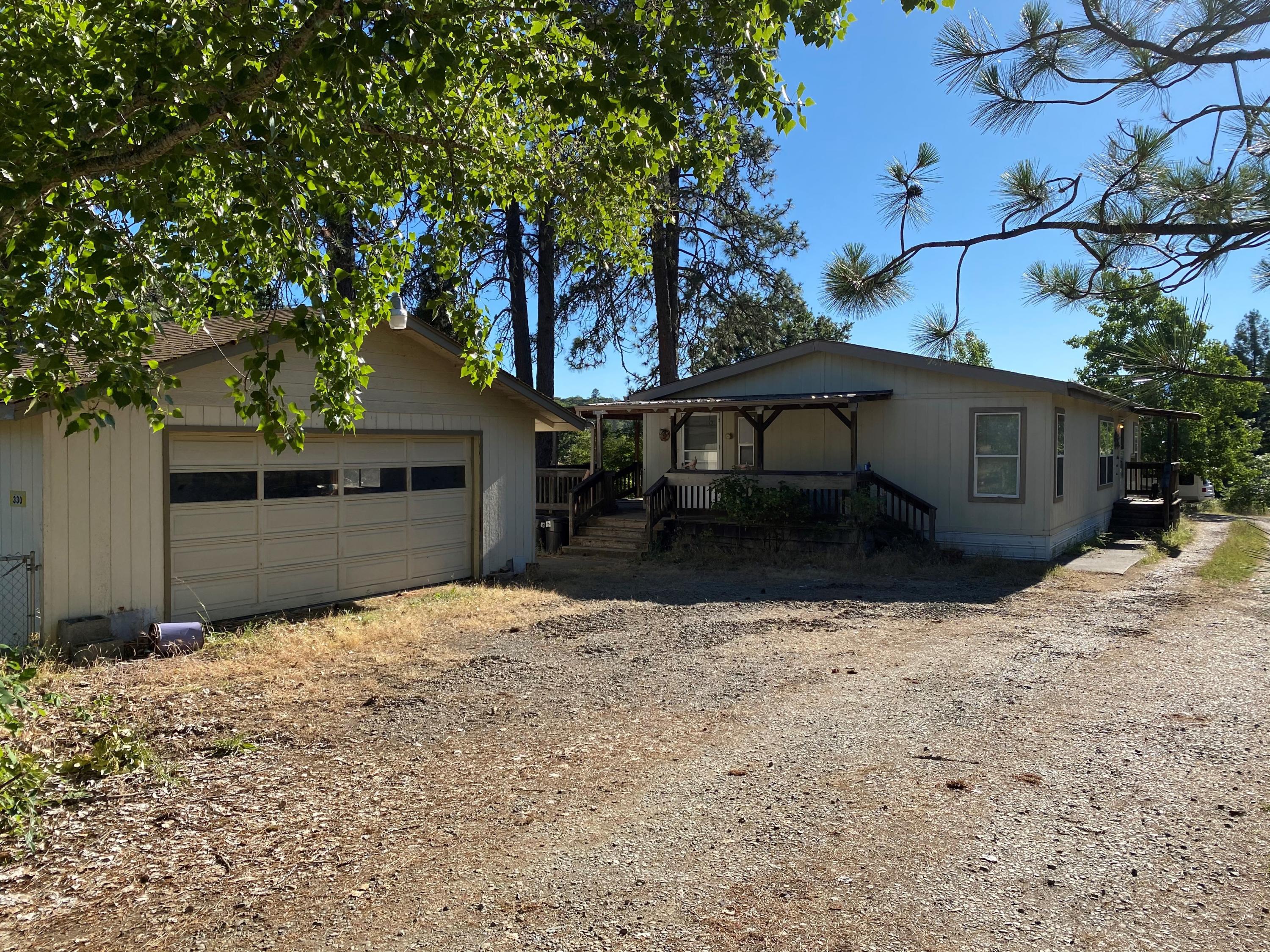 Come enjoy this 3 bedroom 2 bath home in a country setting on   3.56 beautiful acres located conveniently close to the Merlin Airport. The house is a 1,296 square foot 1997 double wide, featuring skylights, ceiling fans, vaulted ceilings,  a split floor plan and open concept living and kitchen area. The master bedroom has vaulted ceilings and a master bathroom with a large easy walk-in shower.  Outside you can enjoy the views of the mountains and 2 fenced pastures on the wraparound deck.  Don't forget to relax by the shaded Koi pond.