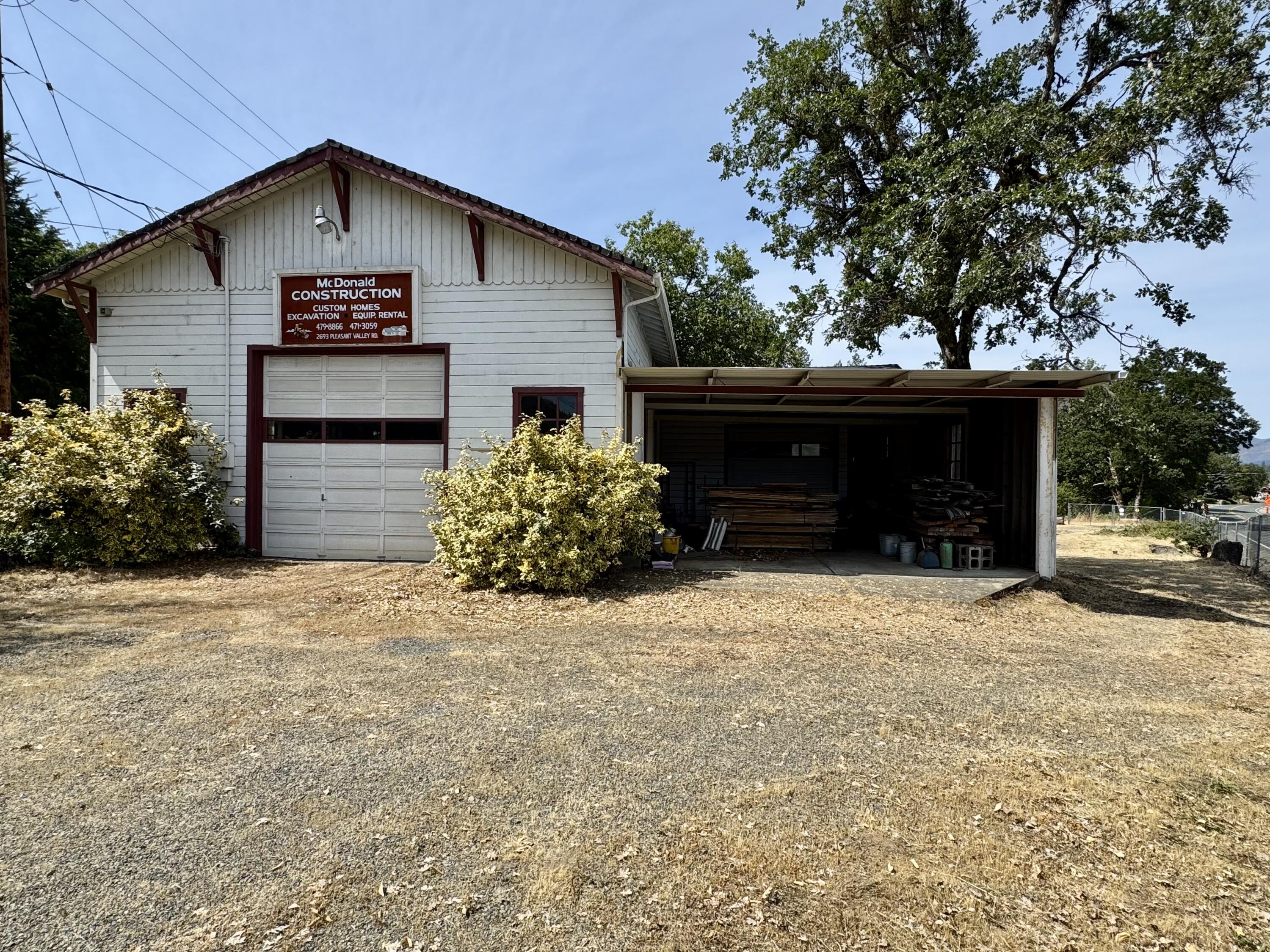 Hard to find Rural Industrial building at the corner of Pleasant Valley Rd and Monument Drive in the North Valley.  Amazing main shop building with 16+ft ceiling & tall roll up door, heavy duty hoist on steel rails the length of the bldg.  Lots of power including 3 phase to run many types of machines.  Additional side shop room with 12+ft ceilings & roll up door opening into large carport style area with slab floor.  A bedroom area, kitchen area, and 3/4 bath room as well.  Building and property being sold ''as is''; buyer to perform their own due diligence.  All information is deemed reliable but not verified; anyone considering purchasing this property should perform theri own investigation into the uses and condition of the property.