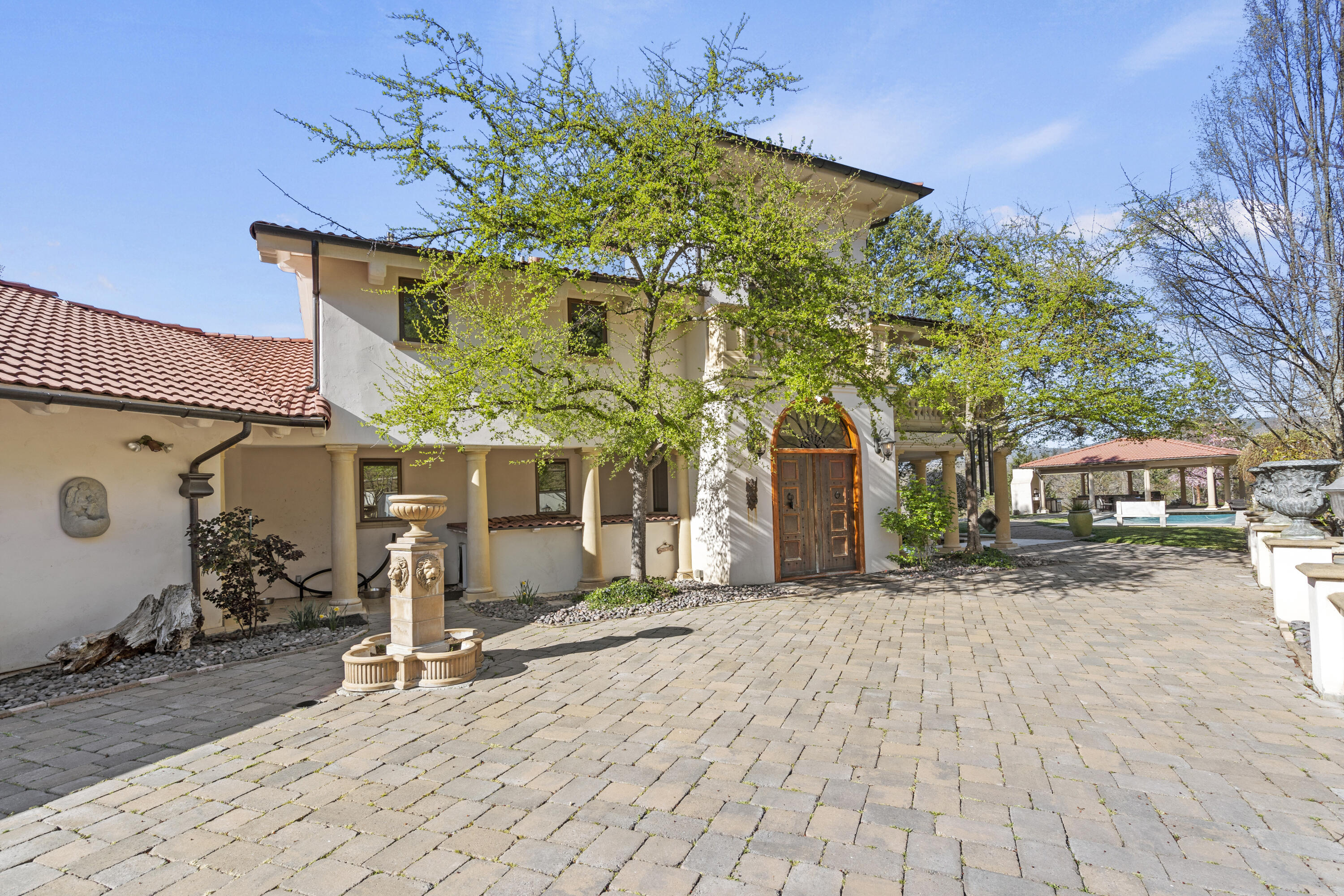 Operated as a successful Airbnb, this 80-acre villa overlooks the valley & Emigrant Lake with privacy and elegance.The 4 en-suite bedrooms captures the stunning views.The chef's kitchen is a showpiece with an oversized island, honed granite, double ovens, prep sink, heated & refrigerated drawers, 3 dishwashers, custom cabinetry and an 8-burner Wolf range.Black Walnut floors throughout, complemented by hand-forged iron railings, marble & tile finishes & 8' solid wood doors.Upstairs is dedicated to the luxurious master suite with a spa-inspired bath, dressing room & an adjacent sitting area framed by a wall of windows. Copper windows, doors & gutters enhance the home's timeless design.Outdoors is equally impressive with an inground pool, expansive paver courtyard, kitchen, restaurant-grade pizza oven & fireplace. Morel highlights incl a hot tub, greenhouse, enclosed raised-bed garden, 1.7 acres of Riesling grapes, tasting studio, 15,000 gal water tank, fruit trees & parking for 10 cars.