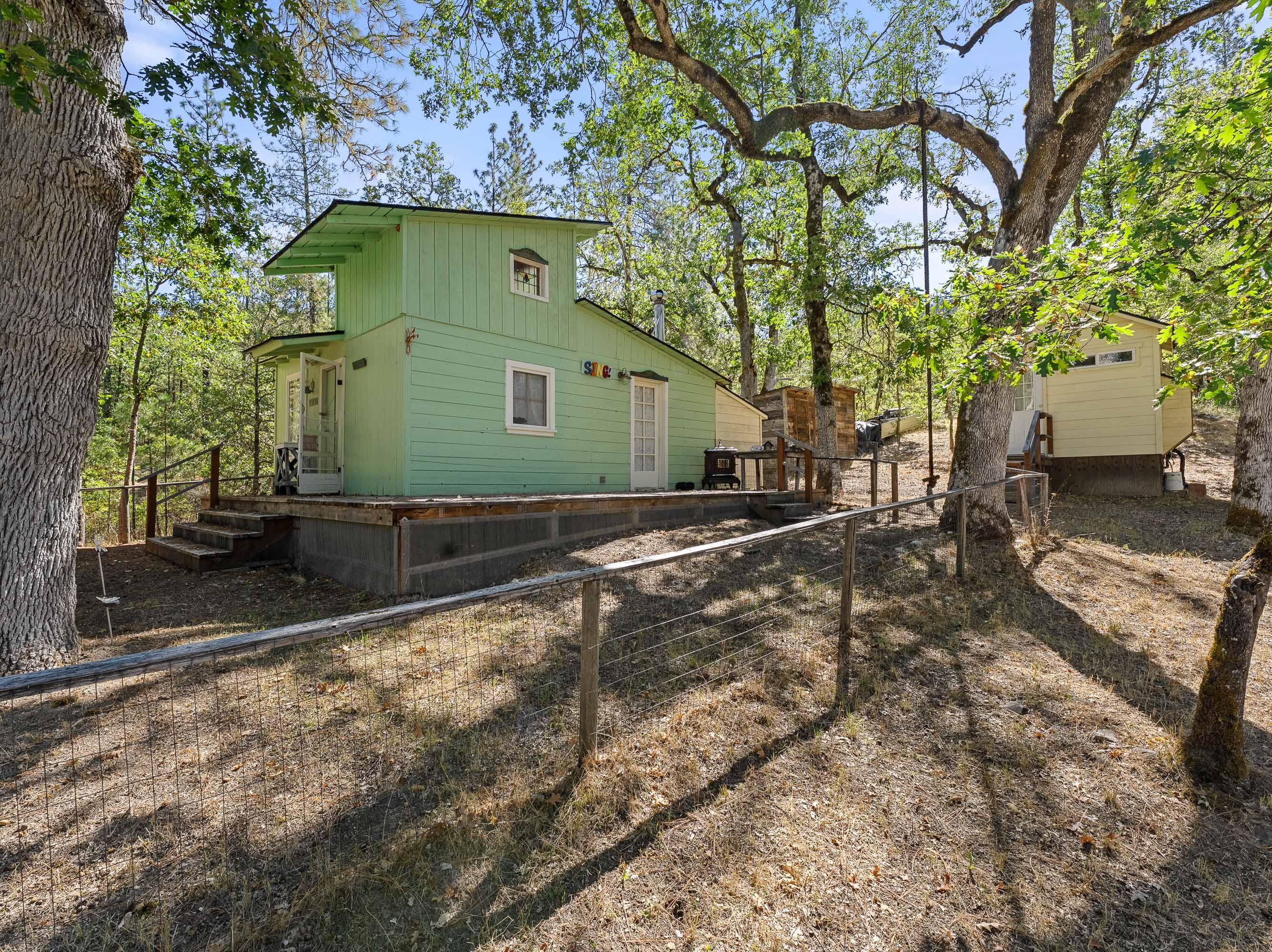 Tranquil Artist Retreat or Multi Family setup with Cozy Main Cabin & Multiple Creative Studios including indulgent Hotel Style Stand Alone Main Bath. 80 Private acres of Beautiful Oregon landscape in Rogue River. Minutes from grocery, gas & the i5 Freeway, yet it feels like you are in a private world miles from the hustle & bustle of life. Original 1970 manufactured home has Grandfather Status but is not habitable. Main Cabin is warm & comfortable with exterior deck under the oak trees with complete privacy. Guest Cabin is a Country Room with mini-kitchen & covered front porch. All the Charm needed and sleeps four. Working Art Studio with utility sink & views of the surrounding forest with an abundance of natural light inspiring creativity. All Guest Cabins are frame built within the previous ten years. Septic and well are in good shape! Your creativity and vision will meet the landscape of opportunity. Don't miss seeing this Beautiful Property in Rogue River.