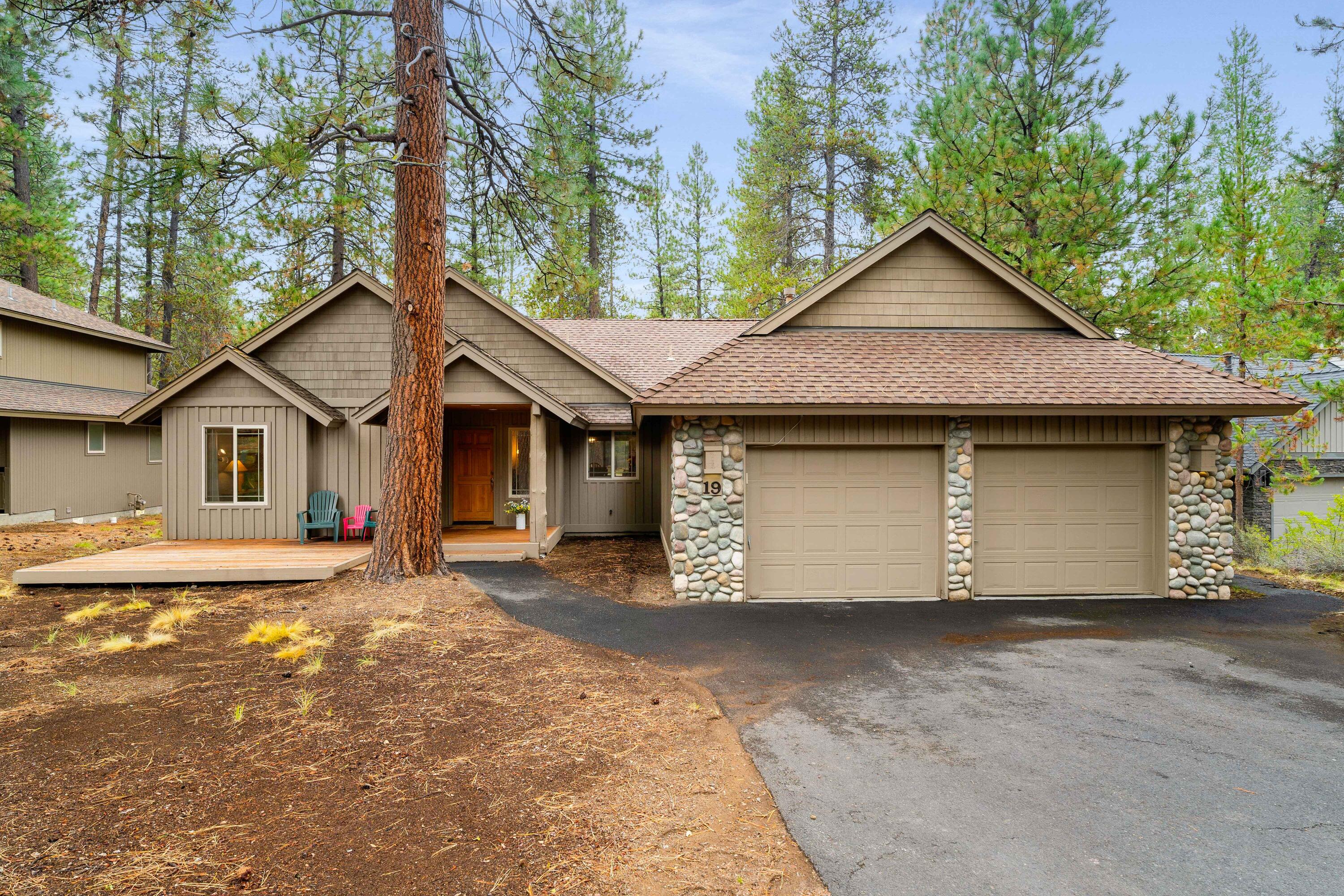 Come experience the warm, inviting cabin feel of this charming single-level Sunriver retreat. Featuring 3 bedrooms and 2 baths, this thoughtfully designed home showcases wood floors, knotty pine cabinetry, and natural accents throughout. The open, vaulted great room offers a spacious kitchen with eating bar and a cozy river rock wood-burning fireplace with convenient gas starter—perfect for gathering after a day of adventure. Enjoy year-round outdoor living with covered front and back decks and a dedicated hot tub enclosure area. Wood blinds, wainscoting, and a river rock-accented exterior add to the rustic charm. A two-car garage provides ample storage, and the home backs to a large common area with easy bike path access. Ideally located just minutes from SHARC and The Village. SHARC paid, this Sunriver classic is truly a must-see!