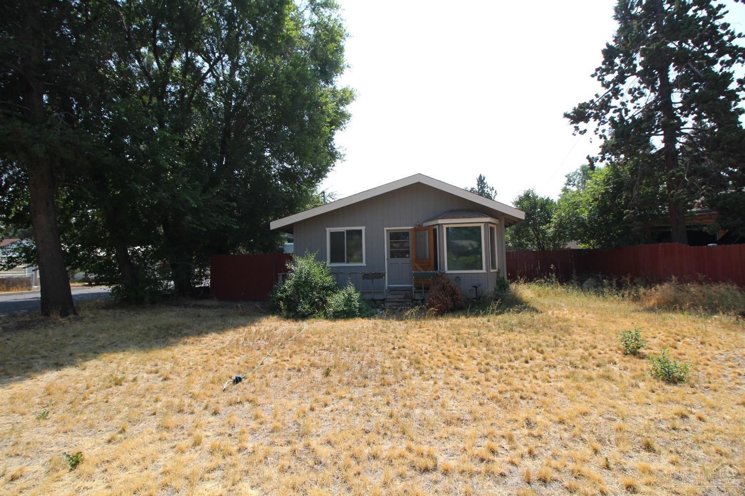 Attention Investors, Lots of potential in this RM zoned corner lot with room to make into a duplex or add a ADU for additional cash flow. Some updates in the interior. Free standing natural gas stove heats the whole place. Useable floor plan. Established landscaping. Conveinent location in Bend good Cash flow.