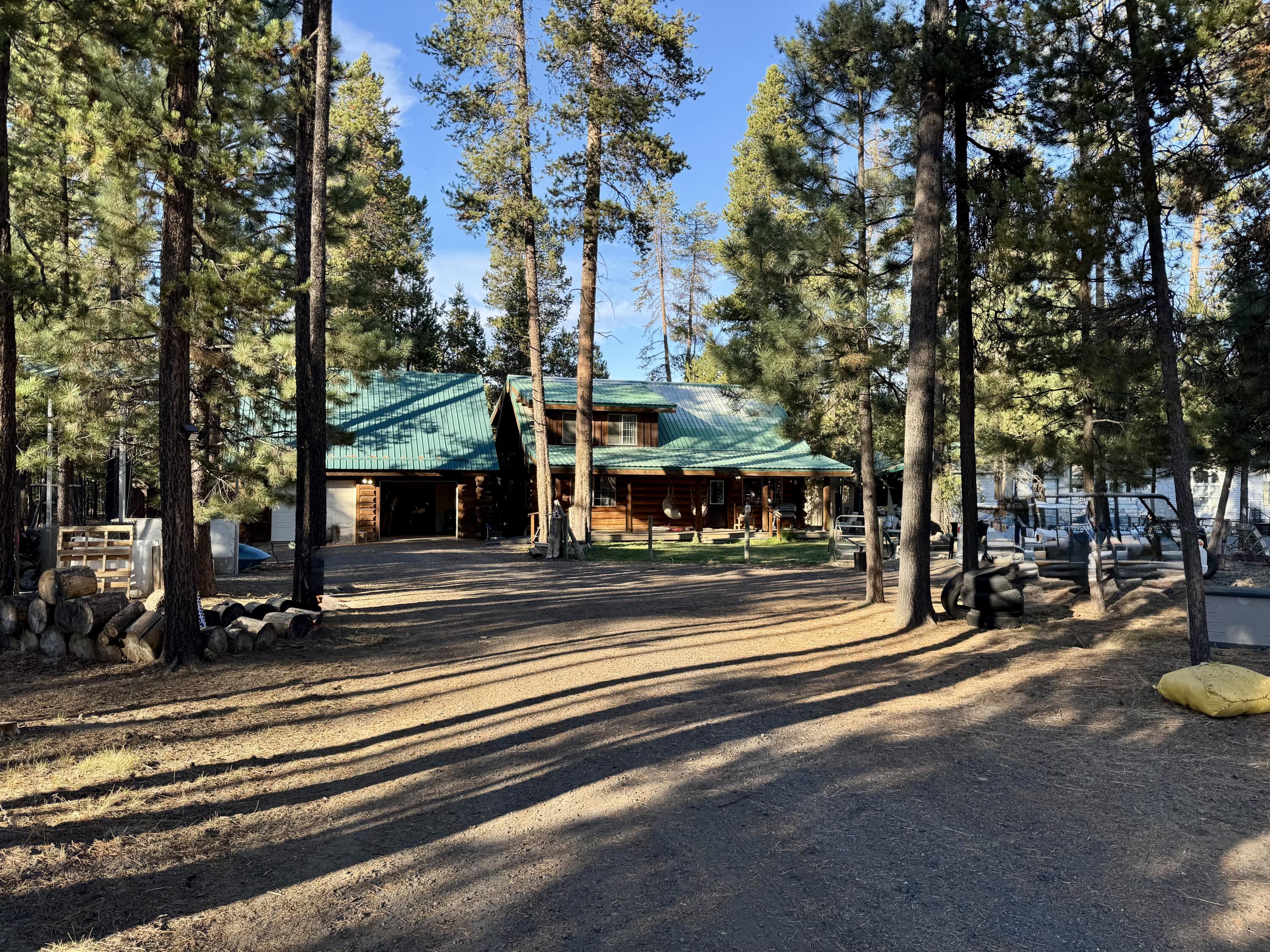 Cozy 2 bedroom, 2 bath log home built in 1997. It offers 1,481 sq ft of living space and 364 sq ft of bonus room above the double car garage. The home's vaulted ceilings, laminate flooring with carpet in Down stair bedroom, and spacious laundry room add comfort and convenience. The primary bathroom has a double vanity and walk-in shower. Enjoy peaceful mornings on the covered front deck or relax in the warmth of the sunroom. Spend the evenings by the crackling fire pit. The fully fenced .95-acre lot offers room for adventures or quiet moments. An RV cover is ready for your travels. This property is a welcoming retreat you'll love to call home.