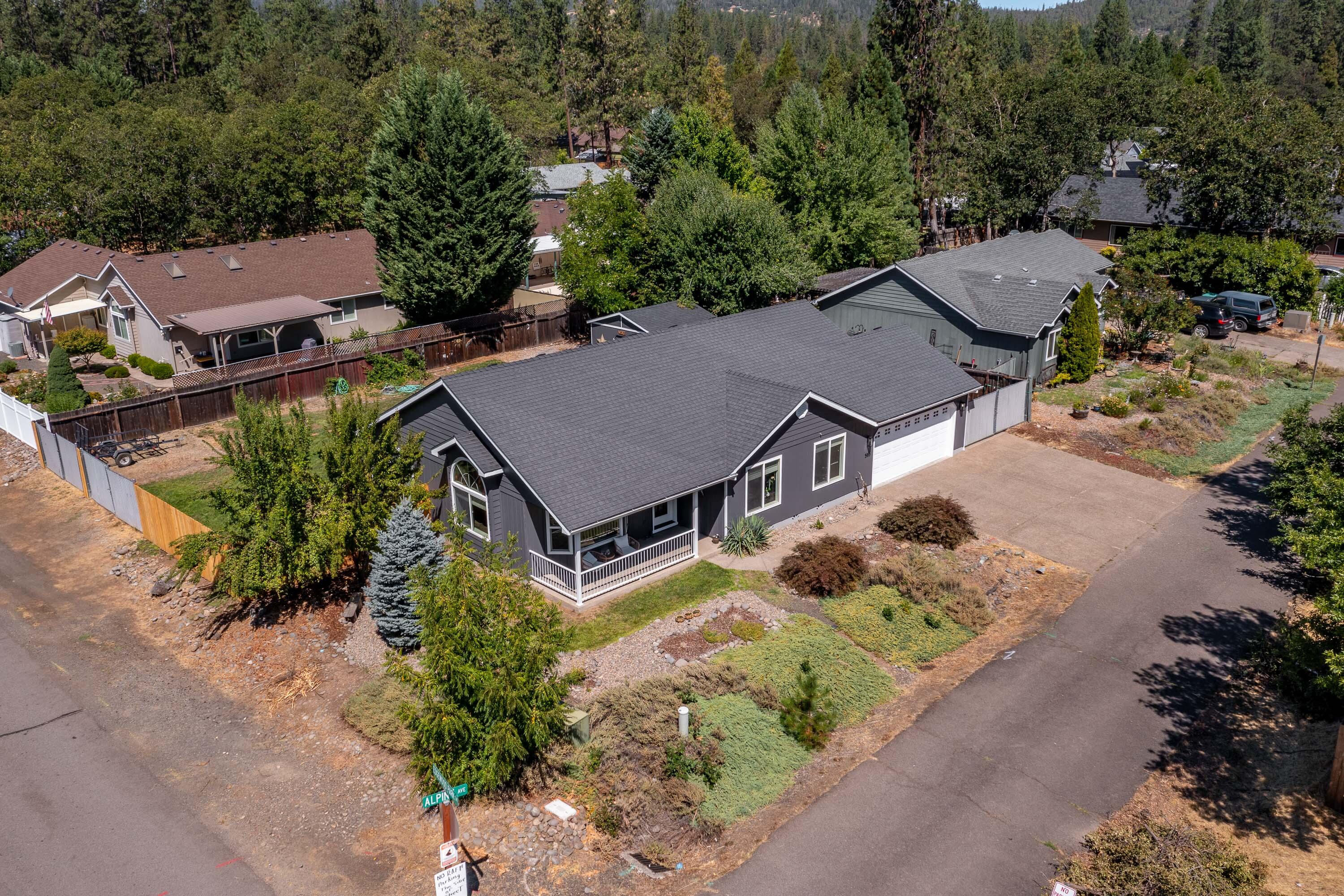 Turn-key home located near the Rogue River in Shady Cove! This 3 Bed/2 Bath home features a 1,394 sq. ft. open floor plan with with vaulted ceilings throughout the kitchen, living area, and primary bedroom adding volume to the home. The primary bedroom also boasts a walk in closet and en-suite bathroom. The kitchen includes oak cabinets and laminate countertops. Recent updates include new exterior paint, new HVAC system, some new fencing, and other various items. Attached 2 car garage. The property contains 2 separate gated areas perfect for parking RVs, Boats, or cars/trailers. The exterior landscape of the property features front and rear sprinklers with a large fenced in backyard perfect for pets and hobbies. Also included within the backyard is a 14'X14' storage shed. Just minutes to several parks and access along the Rogue River. Less than an hour to Crater Lake National Park, Lost Creek Lake, and the Upper Rogue Recreation Area! 25 minutes to Medford and the Medford Airport.