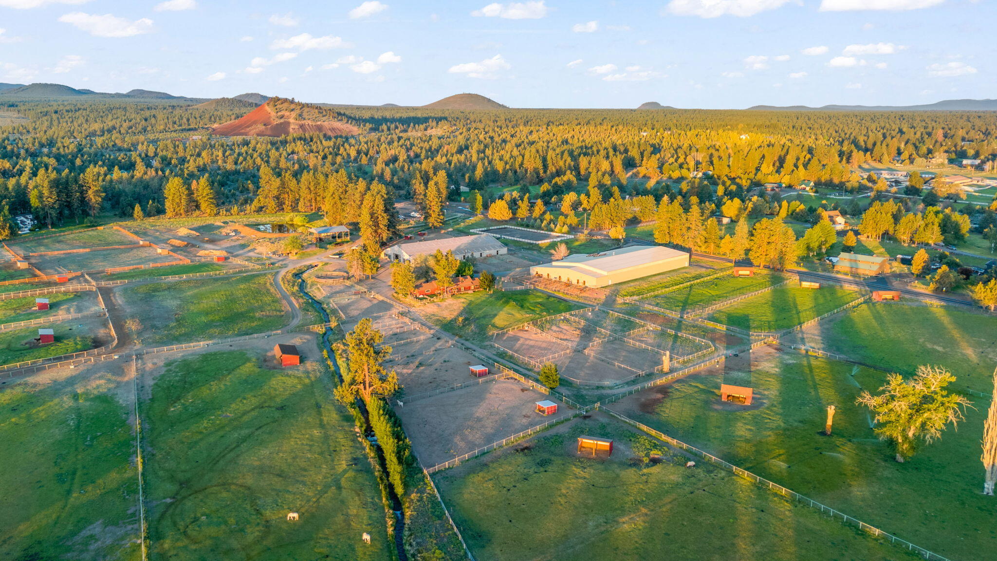 Minutes from town and miles from ordinary, Horse Butte Farms is a Legacy opportunity in the heart of Bend. Currently operating as a full-service boarding & training facility. 62-acres on (4) tax parcels, includes approved CUP for 2nd home-building site. 108x210 jumping arena, 60x168 arena, 100x200 outdoor sand arena, a remodeled 1940's farmhouse, guest yurt, 6-pad 50-amp powered trailer sites and more. $550k+ annual revenue through a variety of established income streams. Fit for an owner-operator, high-end training operation and other dream visions. Soak-in the panoramic views from Pine Mountain sunrises to Cascade Range sunsets. Impeccably maintained and improved for ease of equine operations. (36) stalls, nine with runs, 22k feet of fencing; crossed-fenced pastures & paddocks w/ run-in shelters, automated horse waterers (inside and out) & composting operation. 33-acres irrigation rights uses the easy K-line system. Trail-ride directly to BLM. Serenity and star-filled skies awaits!