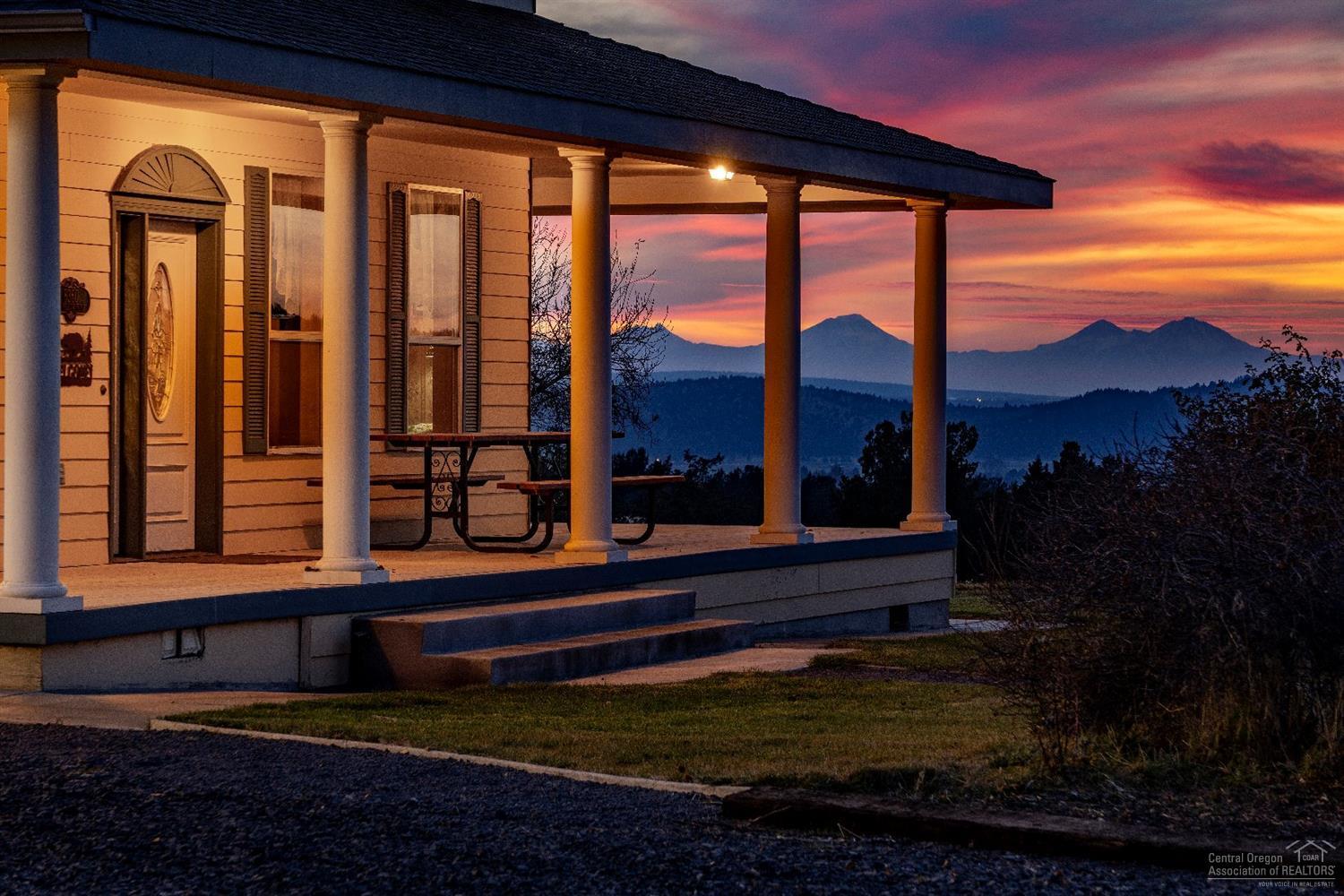 Connect with nature on 164 acres showcasing the Cascade Mountains! Beautiful farmhouse, shop/garage, carport, tool room, bunkhouse, hay shed, new corrals with vet/tack room. Private spring fed, stocked fishing pond with solar powered wind mill. Large wrap around porch invites you to sit and enjoy the cattle grazing and an abundant herd of wildlife that call this property home. Interior of home offers 3 bedrooms, 2 1/2 baths, Italian tile entry, cherry and sycamore wood floors, sun washed oak cabinets, kitchen island, eating bar, dining room plus formal dining room with french doors to living room. Potential to irrigate up to 5 acres out of pond. Eight fenced pastures, including approximately 80 acres of farm ground, most fencing and gates replaced plus extensive juniper removal for increased water and grass potential. LOP tags available. Not far from town but yet private and secluded setting to enjoy country living!
