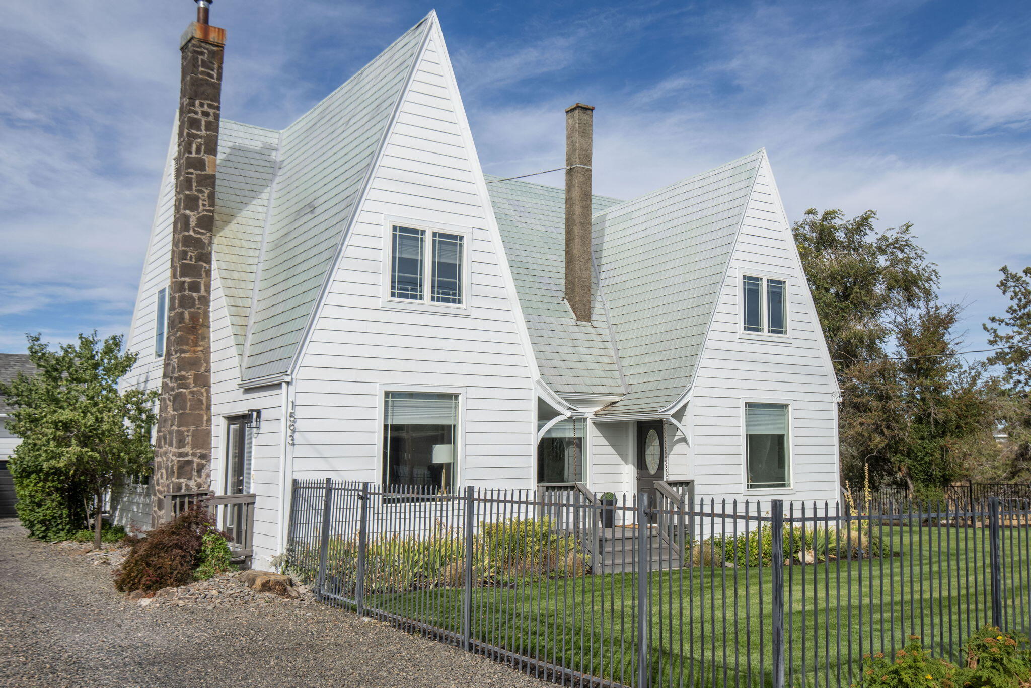 Discover a rare 1930s investment gem featuring 3 distinct units, including two charming homes and a stylish ADU perched above the Dry Canyon. This is perfect for investors or multi-generational living, don't miss this one-of-a-kind property! Amazing RENTAL INCOME and the LARGE lot could be partitioned for investment opportunity. The beautiful Tudor style main home features 4 bedrooms, 2 bathrooms, 2,736 sq ft with new LVP, carpet, mini splits, interior & exterior paint. It's light and bright and SO MUCH MORE. The cottage has 2 bedrooms, 1 bath and 826 sq ft with a great private outdoor space. The ADU is 540 sq ft with one bed, one bath and kitchen. This property is ideally located just minutes from downtown, everything is beautifully renovated seamlessly blending historic charm with modern efficiency. Enjoy stunning views of Smith Rock from the landscaped exterior, complete with updated fencing, vegetation and inviting outdoor spaces. Property also features a spacious three-car garage