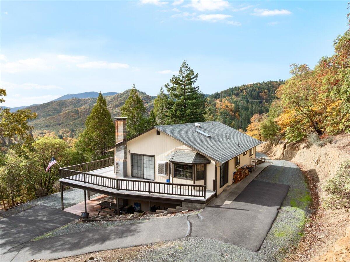VIEW VIEW VIEW.... Step out on your deck and watch the deer roam your property!  These amazing 40 acres are right outside of the quaint little town of Rogue River.  Approximately 10 minutes to town.  Hop on your quad and use the access road to go to the  top of your property, which is overlooking Del Rio Winery.  This roomy daylight basement home has a 2nd kitchen set up on the lower level.  Large 2 car garage. Good sized garden area. Large fenced off area for farm animals,  2 sheds. Large wood storage. 1500gl holding tank. pole barn with a well maintained 5th wheel that is already hooked up to it's own electricity, the homes well, and the homes septic. And yes, ALL is included with the property.  Too much to mention.  Too beautiful to imagine.  Come see for yourself!