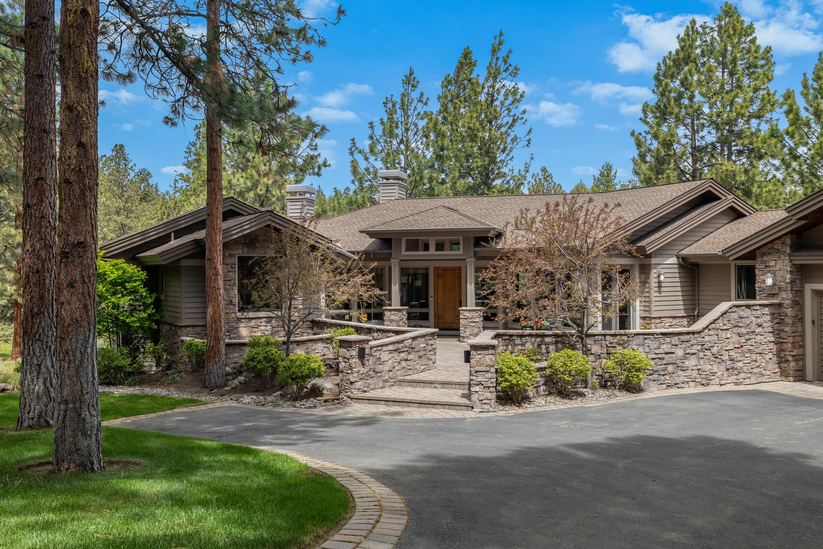 Welcome to your dream home in prestigious Awbrey Glen. Situated above the picturesque #13 Signature hole, this grand traditional residence exudes elegance & luxury at every turn. Constructed by renowned builder Steve Madsen, this home boasts exquisite custom finishes throughout w/gleaming hickory hardwood floors that guide you through the spacious layout. The heart of the home is the chef's kitchen, with granite counters, upscale stainless appliances, pantry, & a casual eating area perfect for morning coffee or informal meals. Entertain guests in style in the formal dining room or unwind in the inviting living room, complete w/a large gas fireplace for cozy evenings. The main level features the primary suite w/gas fireplace, dual vanity, walk-in shower & a dedicated office w/built-in cabinets & desk. The finished lower level features 2 guest bedrooms, each with their own full bath, family room w/gas fireplace, wet bar, walk-in wine cellar and much more.
