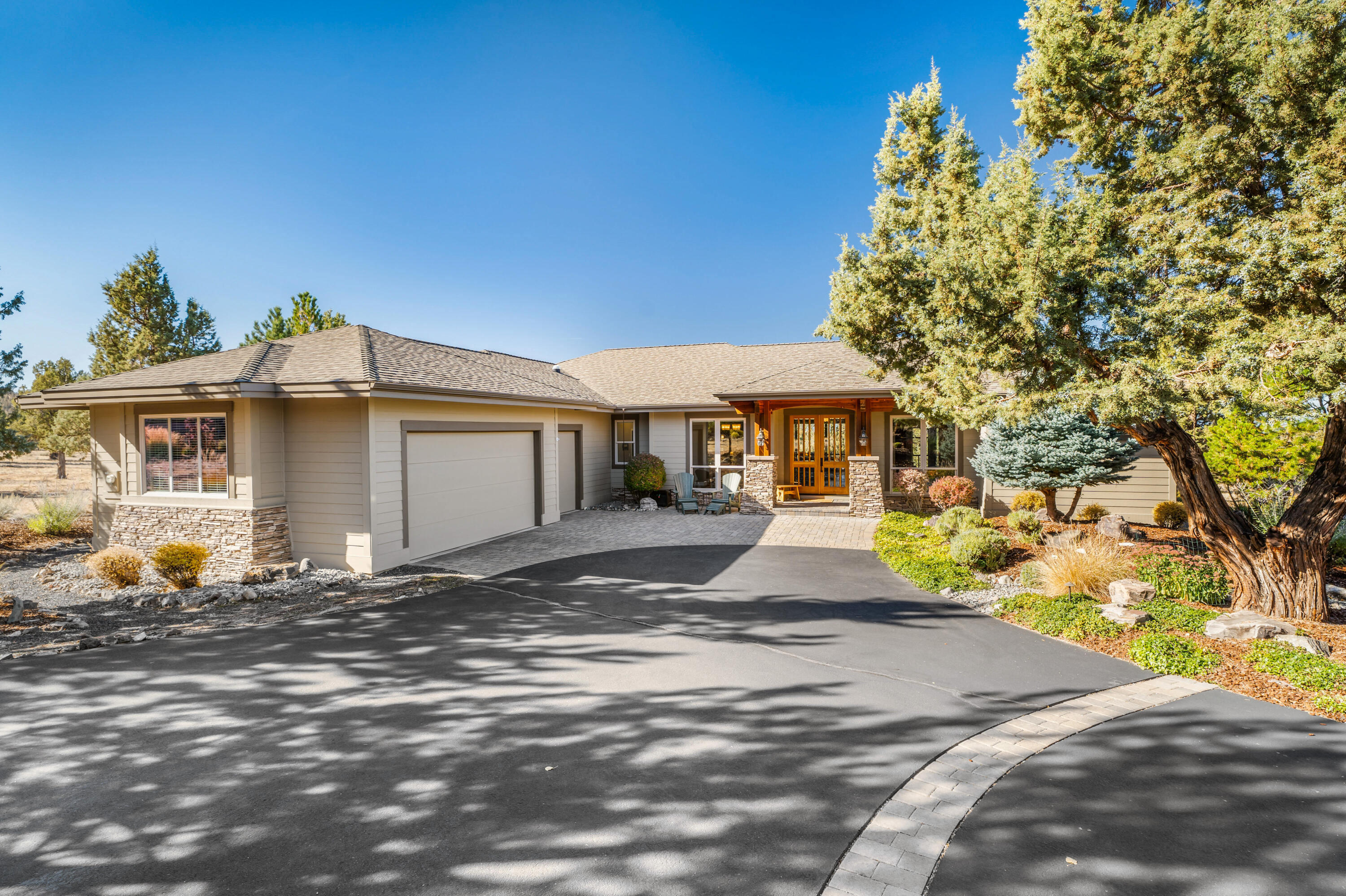 Exceptional single-level home with stunning Cascade Mountain views on the West Ridge in Eagle Crest Resort. This thoughtfully designed residence backs to common space and BLM land, ensuring unparalleled privacy and natural beauty that extends far beyond your property lines.

The open concept floor plan seamlessly connects living spaces, featuring a great room with extensive built-ins and a gas fireplace with stone hearth that serves as the home's welcoming focal point. The kitchen features two expansive islands, solid granite countertops, and multiple dining spaces that make entertaining effortless.

The primary suite offers a large soaking tub, separate shower, and spacious closet. Two additional bedrooms share an adjoining full bathroom, providing comfortable accommodations for family or guests.

Dedicated office space, half bath, laundry room and triple car garage complete this incredible home.