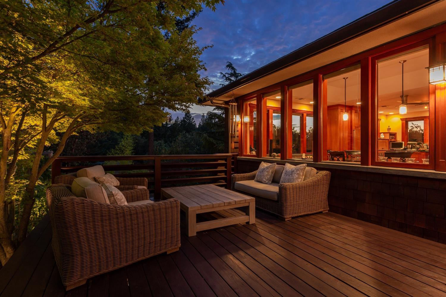 Tucked away on a private drive with breathtaking views and sited in a spectacular, unique setting in the mountains and majestic ponderosa pine forest, this contemporary Craftsman-style custom home is a stunning one-of-a kind work of art. You'll be captivated by the creative use of indoor-outdoor space, Japanese-style gardens, quality woodwork, clean lines, and understated artistic accents which blend in perfect harmony to create this serene, beautiful, and unique home. Detailed custom woodwork throughout was crafted with both native and exotic woods. Walls of windows, soaring ceilings, and rich organic colors lend a quiet elegance to the open floor plan. The expansive gourmet kitchen is a showcase of modern and functional style with mahogany cabinets, quartz counters, and two-sided stone fireplace. Luxurious, private master wing with walls of east facing windows. A remarkable blend of functionality, style, and creativity make this home a showcase of architectural artistry in Ashland.
