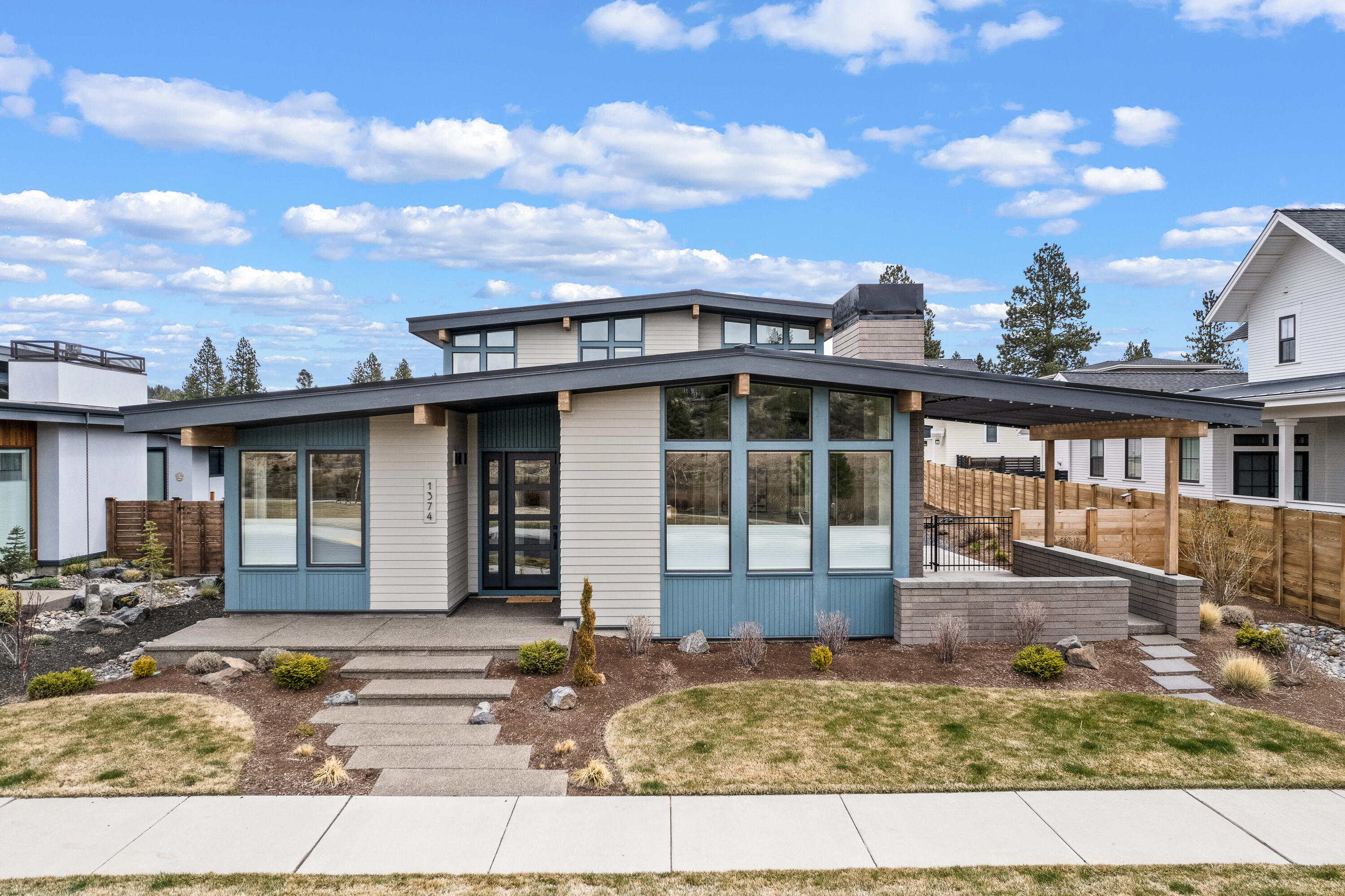 Remarkable Mid-Century Modern home across from Discovery Park in NorthWest Crossing. Contemporary features include slab quartz counters, open great room floor plan, vaulted ceilings, abundant natural light, custom cabinetry & covered outdoor living space. Spacious kitchen with professional series appliances, pantry and large island.  Plank hardwood floors throughout main living area. Primary suite and den on main floor, 2 bedrooms, bonus room and full bath on upper level. Large fenced lot including covered patio and open pergola, 3-car garage. Close to restaurants, trails, schools, and recreation.
