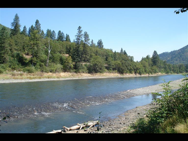 Beautiful Rogue Riverfront Recreational use property with approximately 200' of river frontage, cement retaining wall, small boat ramp, includes newer insulated 20' Yurt, portable kit/bath/shower with water storage, mostly level lot with some trees & new fencing. Great location between Grants Pass & Rogue River. Property has RV plugs- one 50amp, one 30amp & two 15amp plugs. All info deemed reliable but not guaranteed & subject to change.