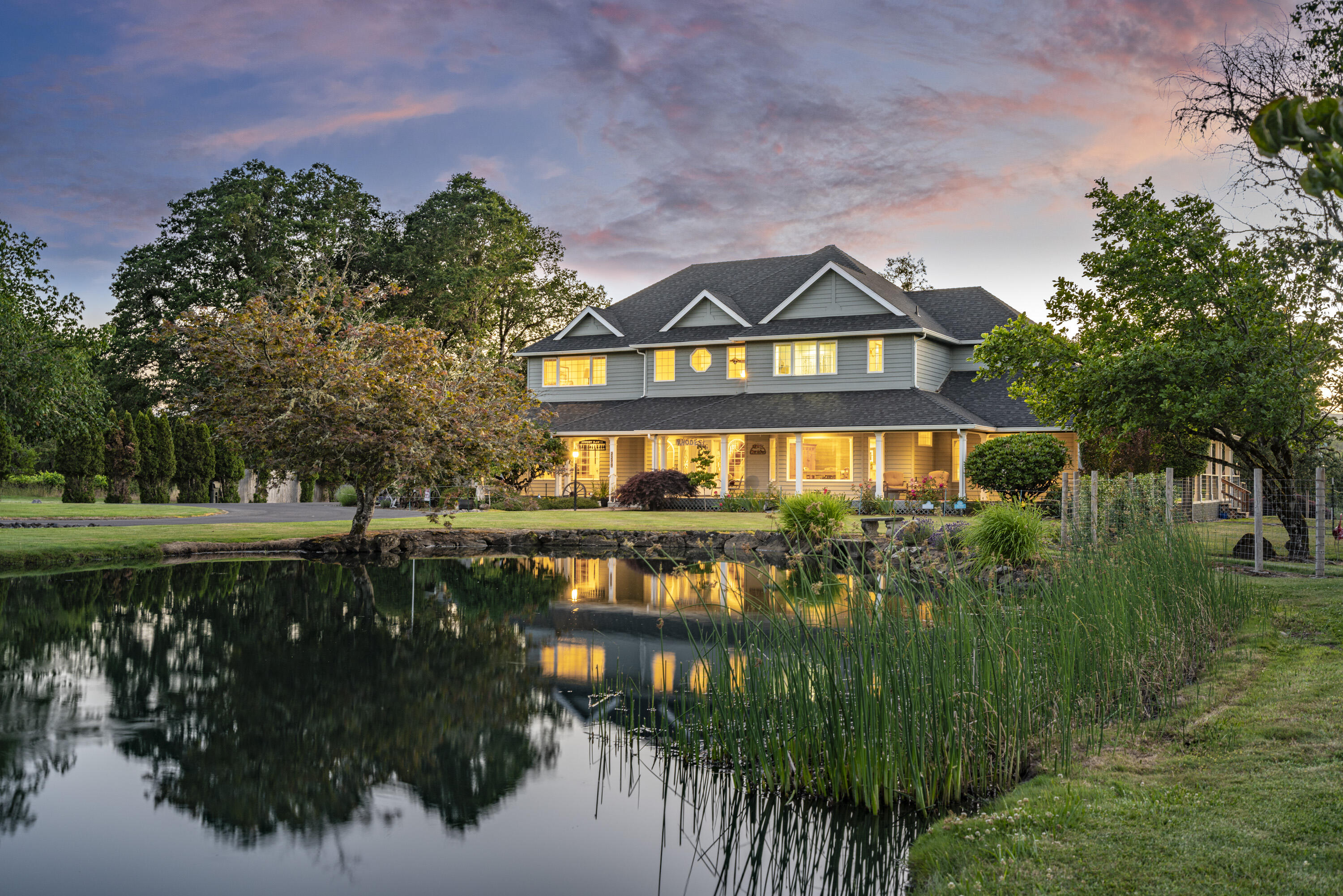 N Umpqua River estate with irrigation, river views, workshop, elegant pond, & lush lawn leading to the river's edge. The home has been elegantly updated with new paint, a roof, a kitchen renovation, a master bath remodel & more! The main floor offers living spaces, dining room, office, full bath, & a kitchen with a large pantry which features hickory cabinets, leathered granite, a large island, & new appliances. The master suite includes walk-in closets, river views, & an impressive custom bathroom with a shower & soaking tub. An ensuite bedroom with full bath, 2 more bedrooms, & a 4th bath round out the 2nd level. A 3,775 SF shop is heated & well insulated, with large doors for easy access of vehicles & larger projects; it includes a finished storage loft. Outside the shop, is a covered carport, & there is a separate RV & trailer barn. Zoned RR-2, there is potential for a partition or the addition of a 2nd home (buyer to complete due diligence)