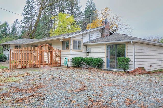 Gardener's Dream- Here's a great home on 2.5 level acres with excellent soil for growing all kind of crops. Features a 3 bedroom, 2 bath, approx. 2016sf, kitchen with island and charming breakfast nook, some hardwood floors, living room with brick fireplace and certified wood stove, open beams, master has hardwood floors and built in desk, cultured marble in guest bath, 3rd bedroom has sink, heat pump, deck, patio, newer comp roof, fruit and nut trees, large garden and fully fenced back part of property, large older barn with loft perfect for workshop or processing crops.