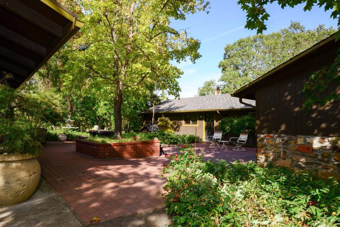 One of a Kind property with a large home and guest house. Drive 3 minutes and you are at the Del Rio Winery for wine tasting or strolling along the mighty and scenic Rogue River! Location, Location, Location this is a rare opportunity to find a property like this, so close to Medford and Grants Pass! 3 wells, 1 barn, 4 car garage/shop (with 220 & compressed air), huge carport with enclosed rooms for storage, shooting shack & range and the list goes on! As you drive up through the beautiful mature trees and scenic pastures you will see a lovely pond with a streaming fountain inviting you into the courtyard of this estate home. The land backs up to BLM , take in amazing views!. The land also has a natural spring. Main dwelling is 3 bedroom, 2 bath, 2751 sqft.