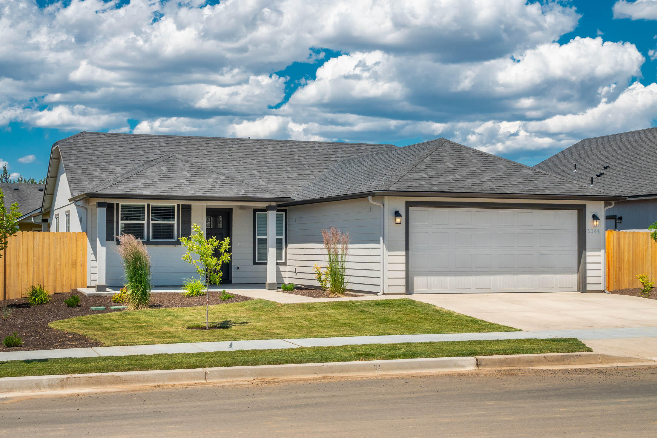 Beautiful ranch home with extended front porch, covered back patio with a mountain view! This lightly lived in home has a perfect blend of modern convenience and classic appeal. The home is on a corner lot and can be more than it appears with vaulted ceilings spanning the dining room and ample quartz counter space with upgraded cabinets. There is a gas fireplace in the great room and central A/C for the summers. The large primary suite has two spacious closets and ensuite with dual vanity. The home is fully fenced and landscaped with sprinklers. The garage has a four-foot extension and comes with a painted floor. Conveniently located with easy access to schools, shopping and recreational facilities. Included is a newer refrigerator and washer dryer. This home is turnkey and ready today.