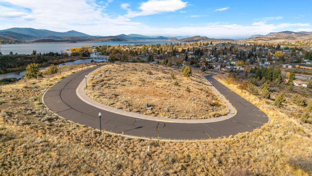 Fantastic views! Discover the perfect place to build your dream home on this lot offering stunning views of both Link River and Klamath Lake. Situated on a paved loop road within an undeveloped subdivision, this property combines peaceful surroundings with the convenience of city amenities. City water, sewer, and power are all available at the street—making your building plans easier than ever. Enjoy nearby access to Moore Park's scenic trails, boat launches, and the conveniences of Sky Lakes Medical Center and OIT just minutes away. A rare opportunity to create your own piece of paradise in Klamath Falls!