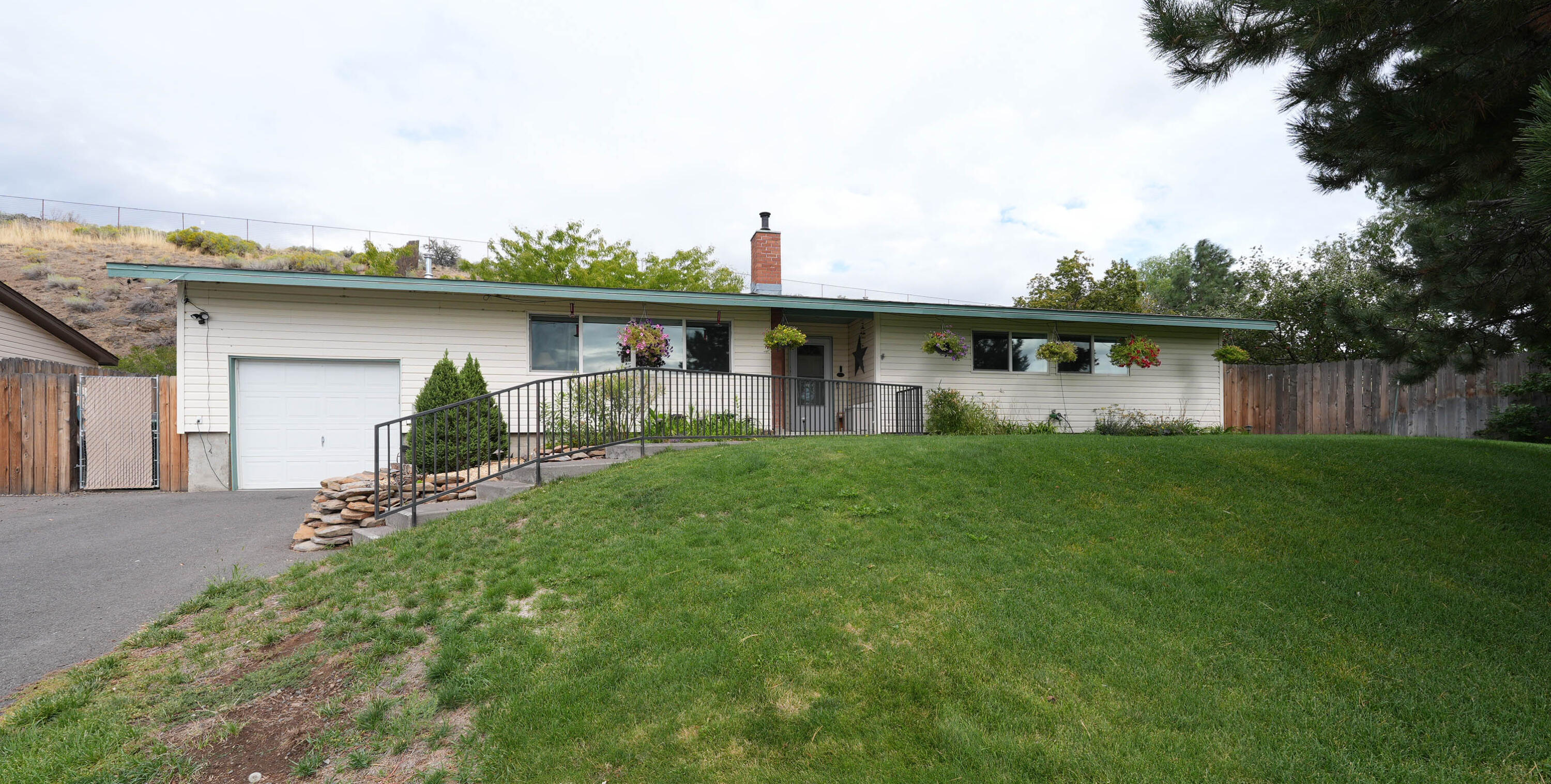 Standalone Home in Private Falcon Heights-Expansive Lot & Stunning Views! Welcome to this rare opportunity in the quiet, gated Falcon Heights community. This 3-bedroom, 1.5-bathroom home sits on the largest lot in the neighborhood, offering spacious front, side & back yards—fenced for privacy or pets. With no neighbors behind or to the south, you'll enjoy a peaceful setting surrounded by open space. Perched on the community's top street, the property boasts sweeping views of the surrounding mountains & valleys. Inside, the home has been thoughtfully updated & meticulously cared for, featuring an updated main bathroom, a newer water heater (installed just last year), central A/C & countless other details that make it move-in ready. Located in the desirable Henley School District, this home offers the perfect blend of comfort, privacy & natural beauty—all within a secure, quiet neighborhood. Don't miss your chance to see this property in person—schedule your private tour today!