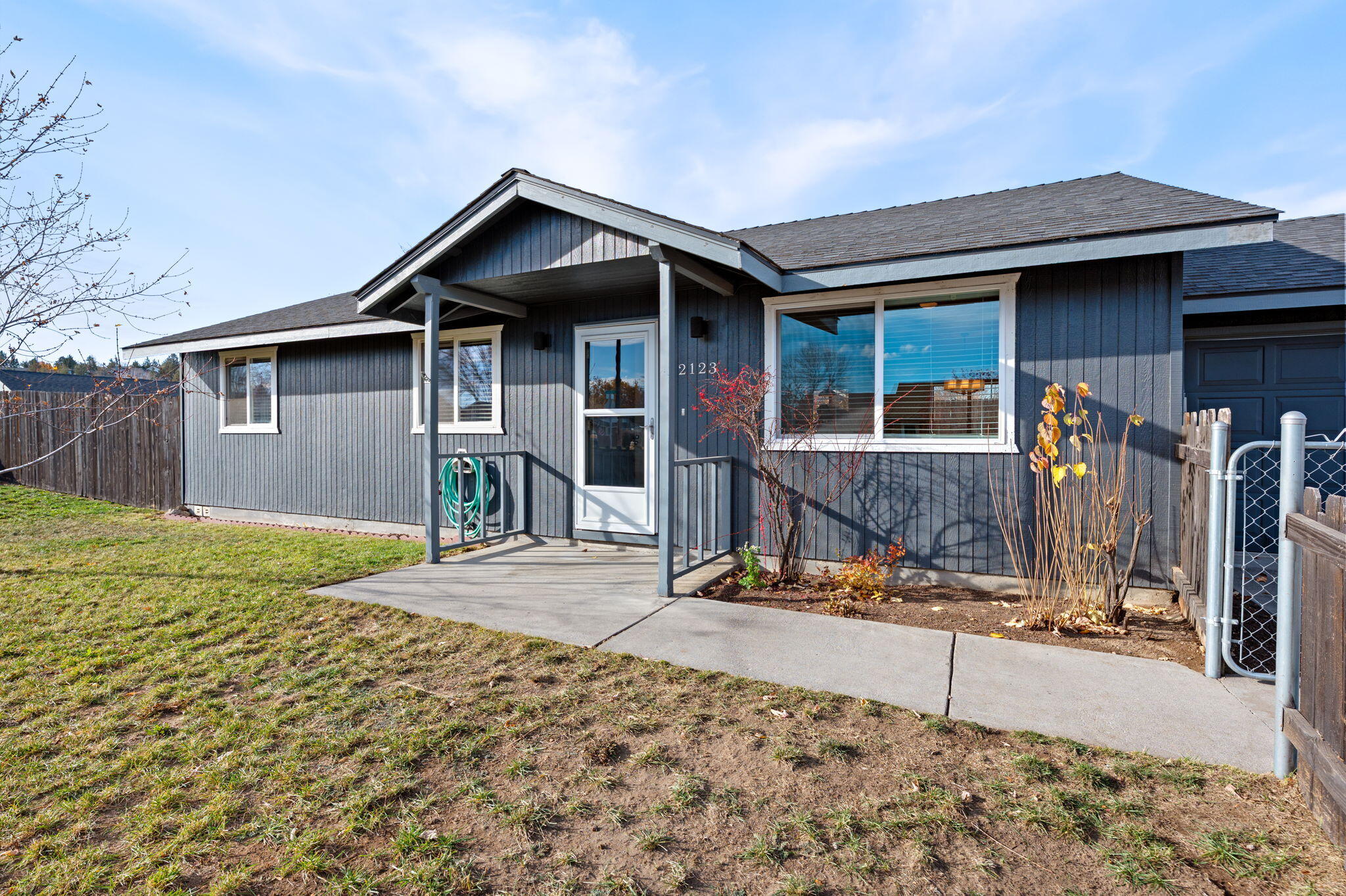 Beautifully updated single level home in Redmond! This charming home lives large with vaulted ceilings, custom lighting, and an open, inviting layout. Recent improvements include newer interior and exterior paint and luxury vinyl plank flooring throughout for a modern, low-maintenance finish. Enjoy exceptional privacy with a fully fenced front yard and an 8-foot fenced backyard—perfect for pets, play, or relaxing outdoors. The spacious corner feels private inside, plus there's room to park an RV along the side of the driveway for added convenience. The garage has been freshly textured and painted, creating a clean, versatile area ideal for storage, projects, or a recreational space. Located just one block from Hayden Park, offering playgrounds, open green space, and plenty of outdoor enjoyment right around the corner.