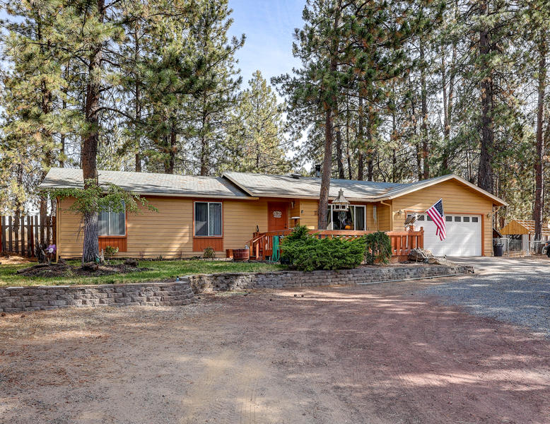 S.W. Bend Home on an Acre with RV Parking! Custom 3Bd/2Ba ranch style stick home features: Great room w/certified wood-stove & wood-lam flooring, open dining/kitchen w/tile floor, granite counters, knotty-alder cabs, newer SS appliances, separate family room w/bar, great fenced backyard w/covered deck, water feature, art studio, gazebo & outdoor kitchen, Electric FA Heat, extra deep 2 car garage w/small shop area, Agate water + well for irrigation, circular driveway + large side RV parking area, Brand New Exterior Paint too!