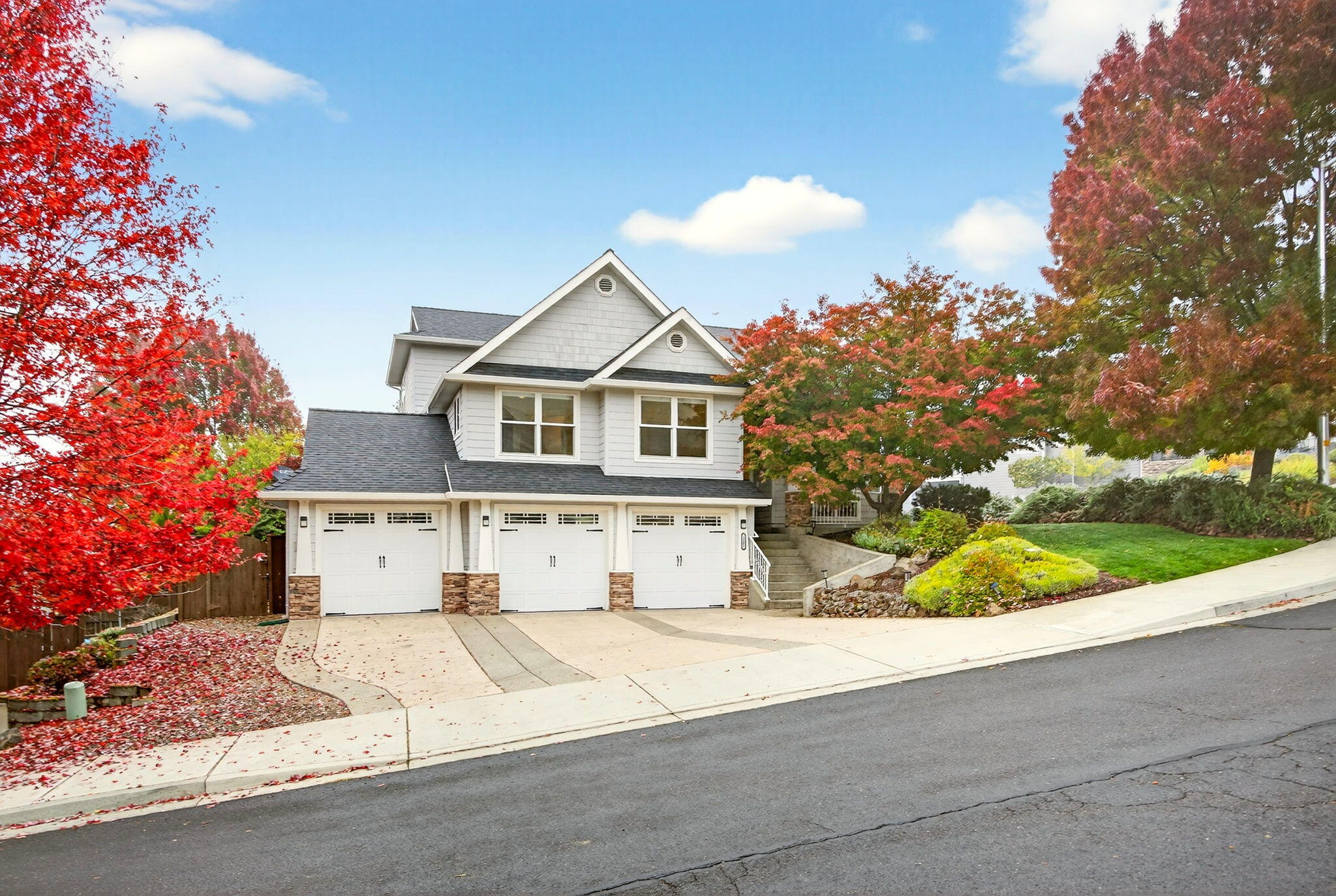Located in the sought-after Eagle Point Golf Course Community, this spacious 2,266 sq ft multi-level home offers 4 bedrooms, 2.5 baths, & a rare 3+ car garage, for extra storage or hobby space. The beautifully updated kitchen showcases sleek finishes including a walnut butcher block island, gas cooktop, wall oven, & a view of the private, fenced backyard. Enjoy cozy evenings in the formal living room with a gas fireplace, conveniently adjacent to the dining area. Main-level office provides the ideal work-from-home setup. Rich Brazilian Cherry floors throughout the main level, adding warmth & sophistication. Downstairs, a second living area opens to a spacious backyard w/ large concrete patio and mature landscaping. The primary suite is a true retreat, featuring stunning mountain views, a large jetted tub, dual sinks + new shower glass doors/surround. Abundant natural light, new roof, fresh exterior paint & move-in ready condition, this home is just moments from golf, dining, and more.