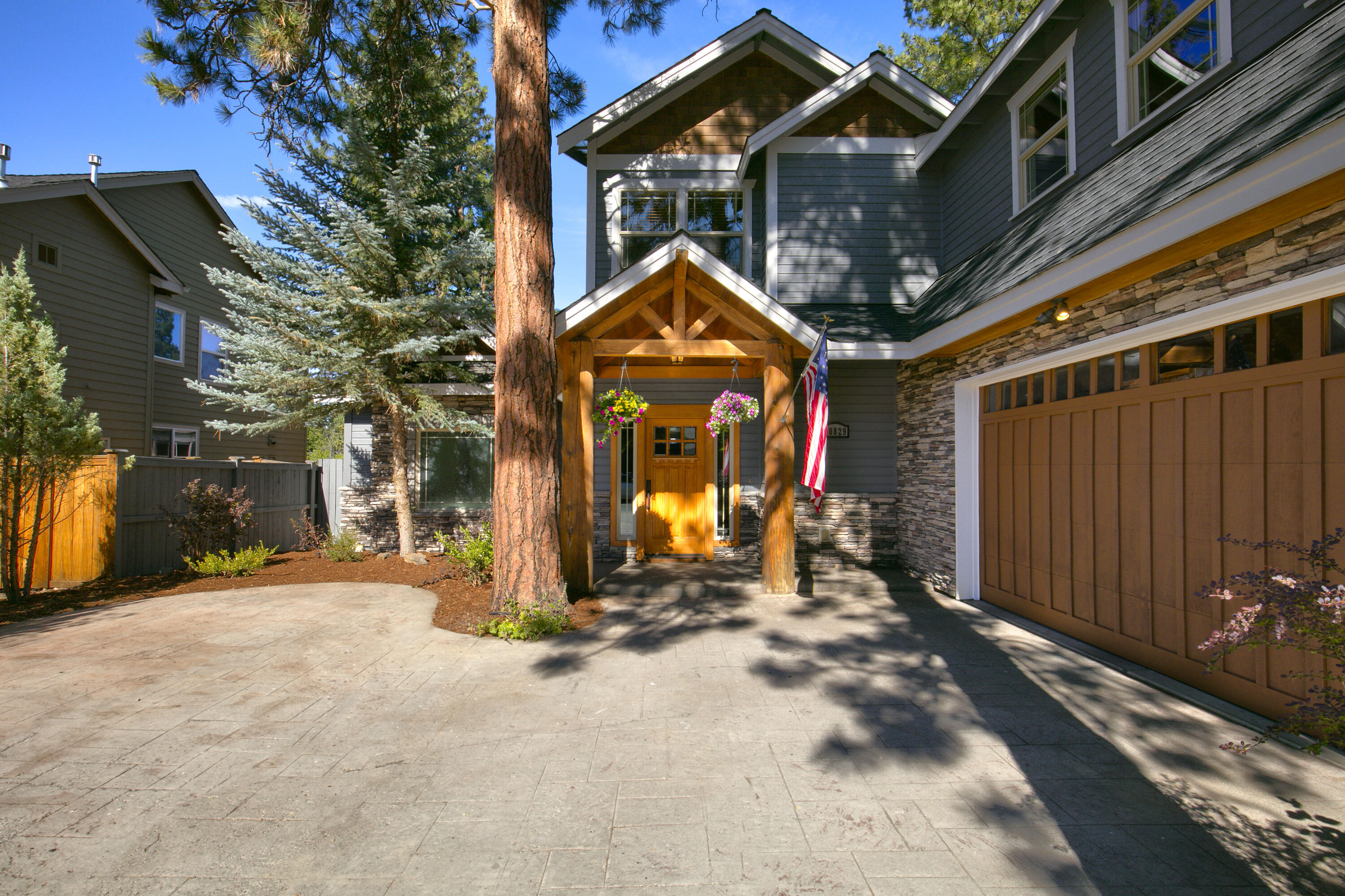 This exquisite SW Bend home with a rare, versatile floor plan! Offering 4 bedrooms (primary on the main), dramatic two-story windows, and a spacious bonus room. The great room is bright and welcoming with a gas fireplace, while the kitchen boasts Mt. Bachelor views, abundant cabinetry, island with gas cooktop, and bar seating. Step outside to a covered patio, hot tub, water feature, and fenced yard. The main level also features a dining room or office. Upstairs includes a bonus room, 3 bedrooms, and 2 full baths. The luxurious primary suite has a T&G ceiling, fireplace, jetted tub, tile shower, dual sinks, and two walk-in closets. An oversized 2-car garage with extra parking, owned solar panels for low utility costs!