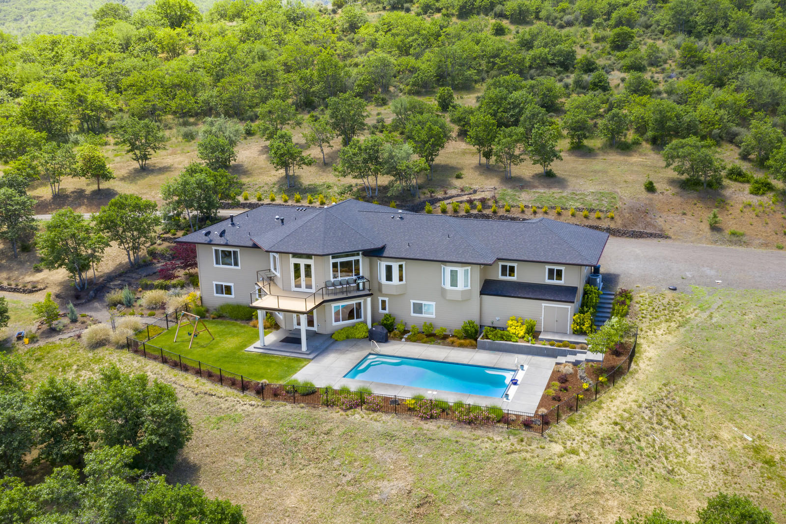 Live the Ashland dream on 12.29 private acres. Perfectly perched w/views 
at every turn, this home was custom built w/no stone left unturned.The 4BR/4.5BA 4101SF home features main-level living at its best..maple flooring, large windows & gourmet kitchen! Open to the kitchen is the dining area, living room w/gas FP & vaulted ceilings + viewing deck. The master suite w/an ensuite bath, walk-in closet + office. Also on the main level you'll find a powder room, 2nd bedroom, bath + laundry/mud-room. On the light-filled lower level you'll again be greeted by views galore. A great room w/direct pool access & large bar area allows for a nice separation for guests. Also on this level you'll find a 2nd master w/ensuite bath, 4th bedroom & add'l bath. Large bonus storage areas are also on this level.  A salt water pool w/electric cover complete this home w/solar + heater for transition months. Irrigation system, propane generator & 5KW's of solar are just the beginning. See attached amenity list