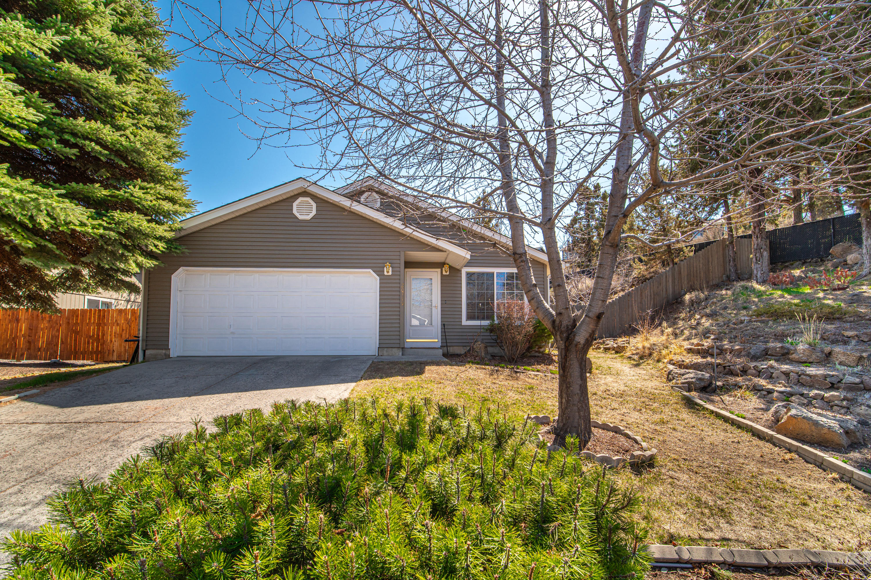 If you are looking for privacy in town this property is for you !  Park like setting in your back yard.  Located on the NE side of Bend. Tiled counter tops, backsplash, wood floors, and AC are a few of the features this home offers.
 3 Bedrooms
 Two bathrooms
 Two car garage
Easy to maintain smaller sq ft home. Would make a great rental or primary residence.