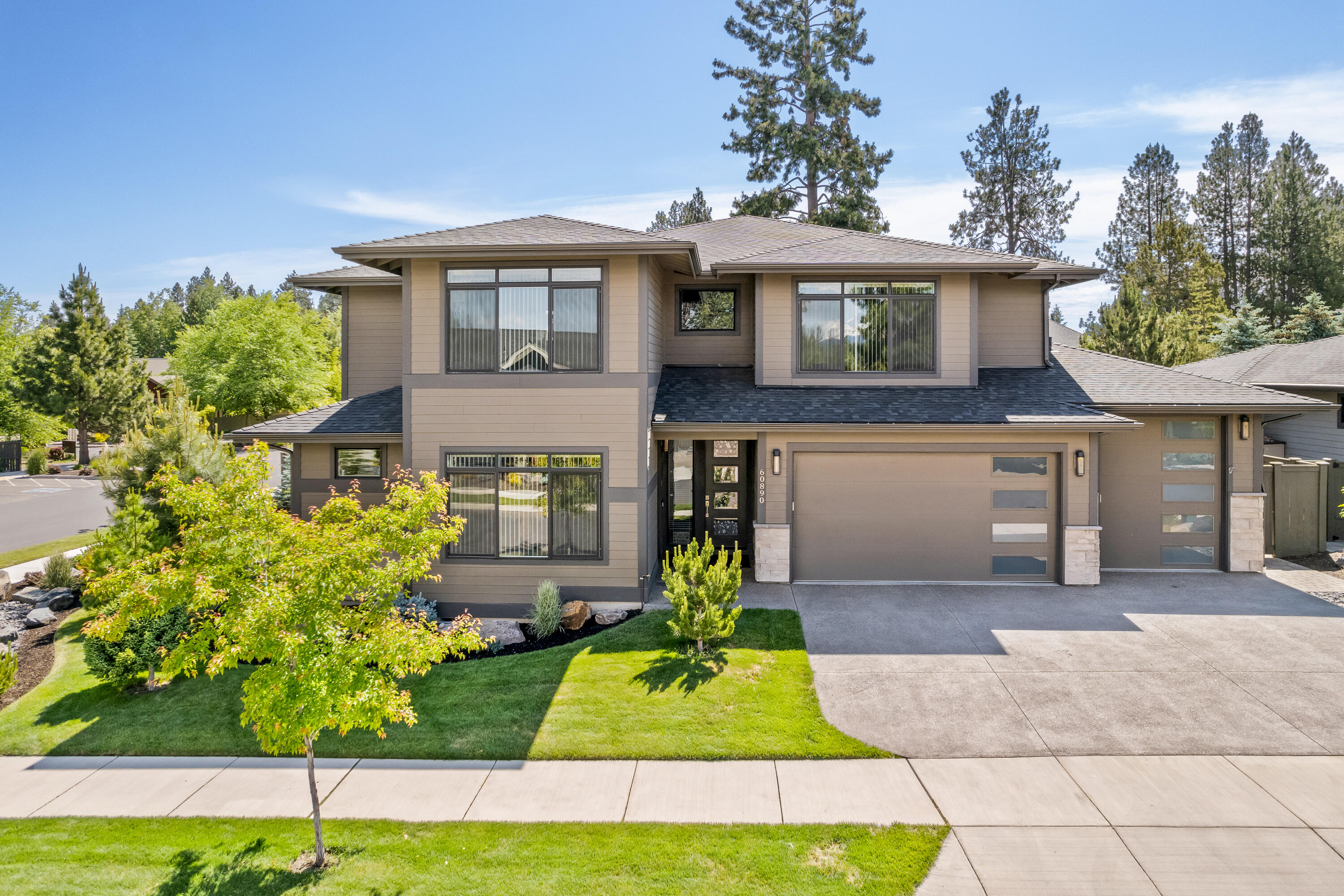 Nestled on 1/4-acre, this spacious residence in SW Bend's River Vale community boasts over 3900 sq ft of luxurious living. Privacy reigns supreme in this haven, which features 5 bedrooms, 3.5 bathrooms, and a bonus room. The attached ADU with separate entrance offers endless lifestyle possibilities, striking the perfect balance between togetherness and seclusion. The heart of the home revolves around a great room, complemented by a dining area and a stunning chef's kitchen designed to be the focal point of the space. The 3-car garage boasts an oversized 10' bay door and ample storage for all your belongings. Step outside to a beautifully landscaped corner lot, where you'll find a covered outdoor living area complete with an outdoor kitchen and pergola, providing exceptional privacy for your relaxation and entertainment needs. Views of the Cascade Mountains, access to the Deschutes River directly across the street, and proximity to trails round out this unique offering.