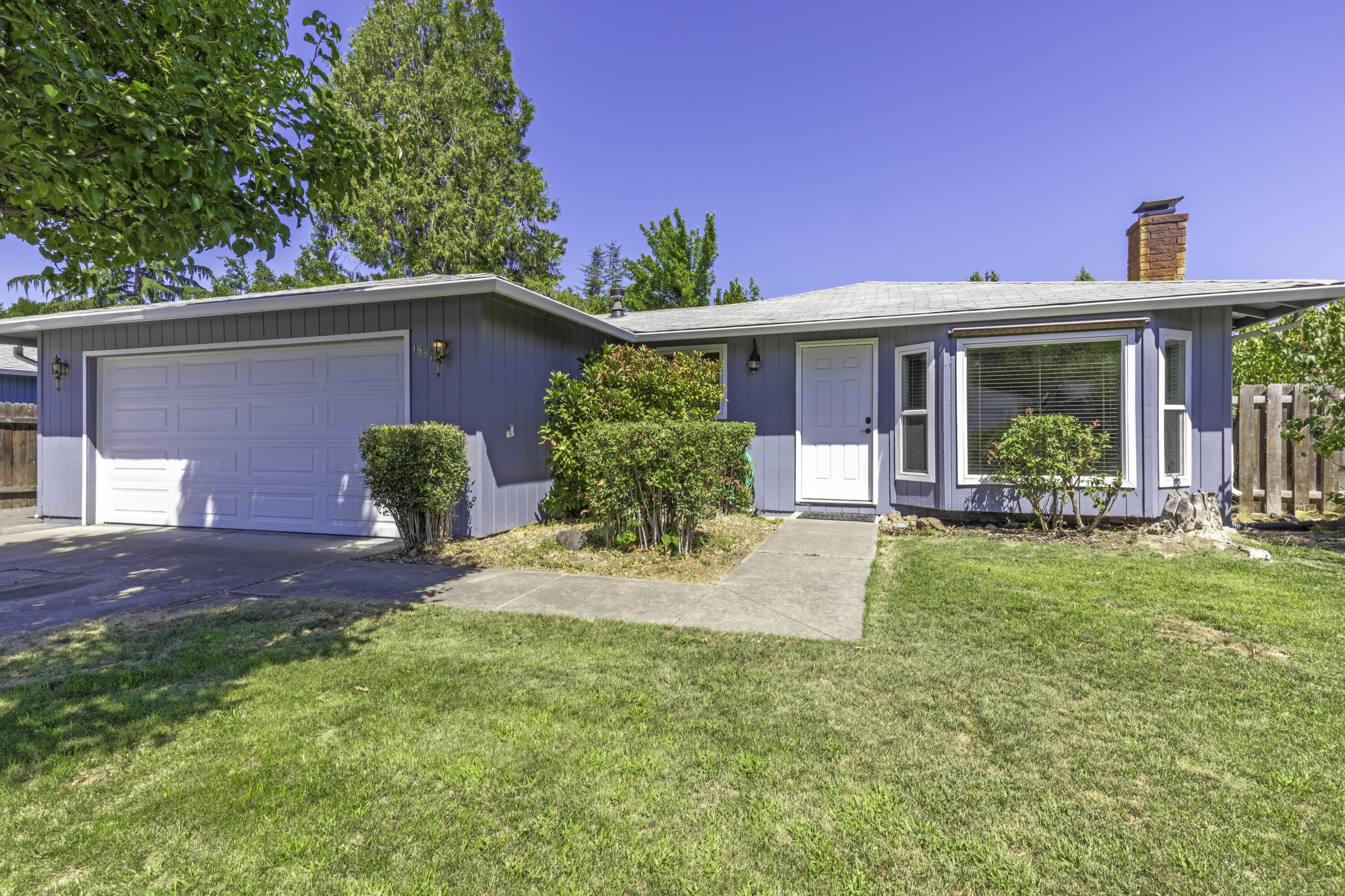 Charming 3 bed, 2 bath home on a 6,534 SqFt lot w/ RV parking, & a fully fenced backyard. Enjoy gardening in your own lg dedicated plot w/an automatic sprinkler/drip system. Relax in the hot tub or unwind on the covered patio & deck. The 2-car attached garage features a new door & opener. Inside, you'll find a cozy woodburning fireplace, bay window w/seat, & vinyl windows. Stainless steel fridge, microwave, & stove included, along with a built-in dishwasher.  New TRANE HVAC system & 1-year First American Home Warranty included for peace of mind. Don't miss this adorable home!