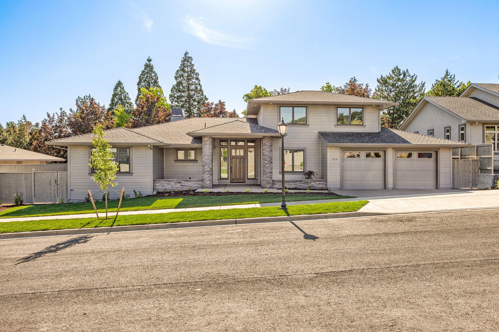 Discover refined living in this stunning contemporary home in the prestigious Summerfield subdivision. With exceptional curb appeal and modern elegance, this thoughtfully designed residence features 4 spacious bedrooms, 2.5 luxurious bathrooms, and a versatile upstairs bonus room—perfect for entertainment or relaxation.  The main level hosts all bedrooms, including a serene primary suite with a spa-inspired bath, floating tub, walk-in shower, double vanity, and large walk-in closet. The open-concept kitchen and living area impress with a floor-to-ceiling tiled gas fireplace, custom built-ins, premium KitchenAid appliances, quartz island, and soft-close cabinetry. Vaulted ceilings and expansive windows fill the space with natural light, complemented by rich hardwood floors and elegant tile finishes.
A generous two-car garage includes an extra 12.5' x 15.5' shop space, ideal for storage or projects.   Enjoy the nearby Summerfield Neighborhood park with playground and pickleball courts.
