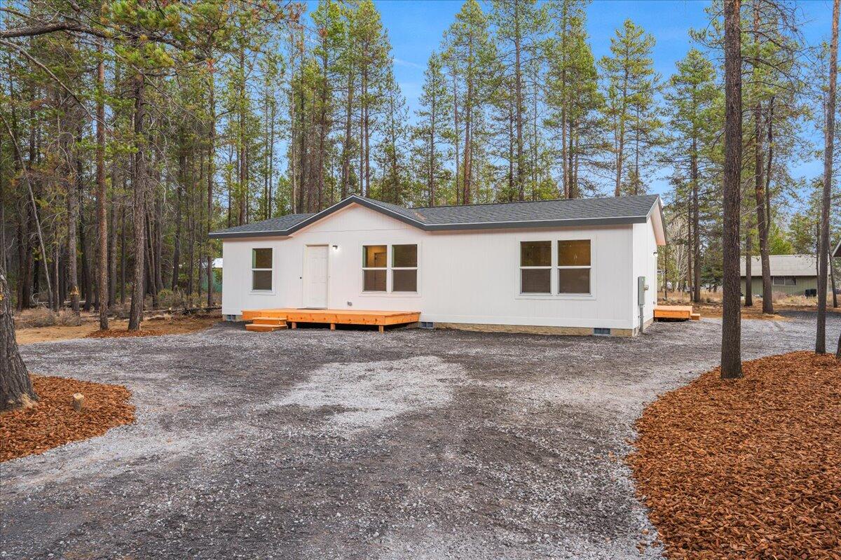 Welcome to the most affordable brand-new 3-bedroom, 2-bath home on 1/3 acre in Deschutes County! Connected to city sewer and water in a new development, this home sits off a county-maintained road with quick access to Highway 97, making trips to Bend easy, all in the charming small-town community of La Pine. Enjoy nearby trails, rivers, and lakes. Inside, an open floor plan features a master bedroom with bath, two additional bedrooms, a second full bath, and an open kitchen flowing into living and dining areas with abundant natural light. This energy-efficient home helps save on utilities year-round. Large front and back decks are perfect for entertaining. The oversized yard offers room for parking, toys, shed, shop, garden, or more, with a privacy fence separating neighbors. Don't miss your chance to own a brand-new, affordable home with a blank slate to make it your own!