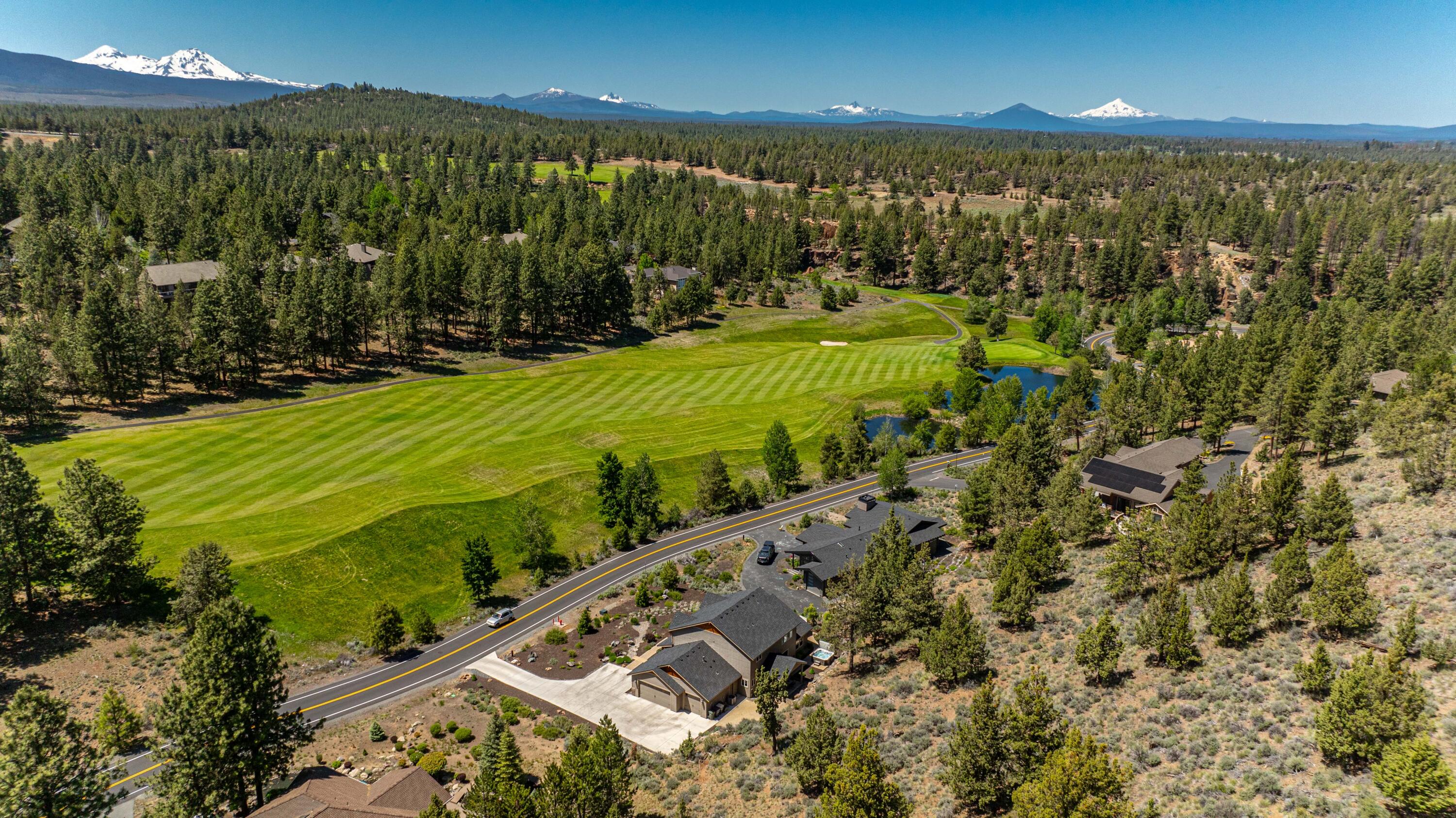 Located in the heart of Bend's west side and yet a world away, this Awbrey Glen home blends the tranquility of life along a lush fairway with the quiet dead end street. Here, you'll find a thoughtful floor plan with office, dining room & an open concept main living space that flows seamlessly to a covered back patio. Built around a center island, the kitchen includes 2  ovens, 5 burner gas cooktop, granite counters & butler's pantry with beverage fridge. The main level primary suite has dual walk-in closets, custom tile shower, soaking tub & heated bathroom floors. Attention to detail continues upstairs, with a large bonus room and 3 ensuite bedrooms. Take advantage of the iconic Deschutes River Trail, just two blocks away, or quiet moments on the private back patio. A covered front porch overlooks custom native landscaping with drought resistant plants & natural stone while a 2.5 car garage, bonus storage space & plentiful parking add the extra touches you can't do without!