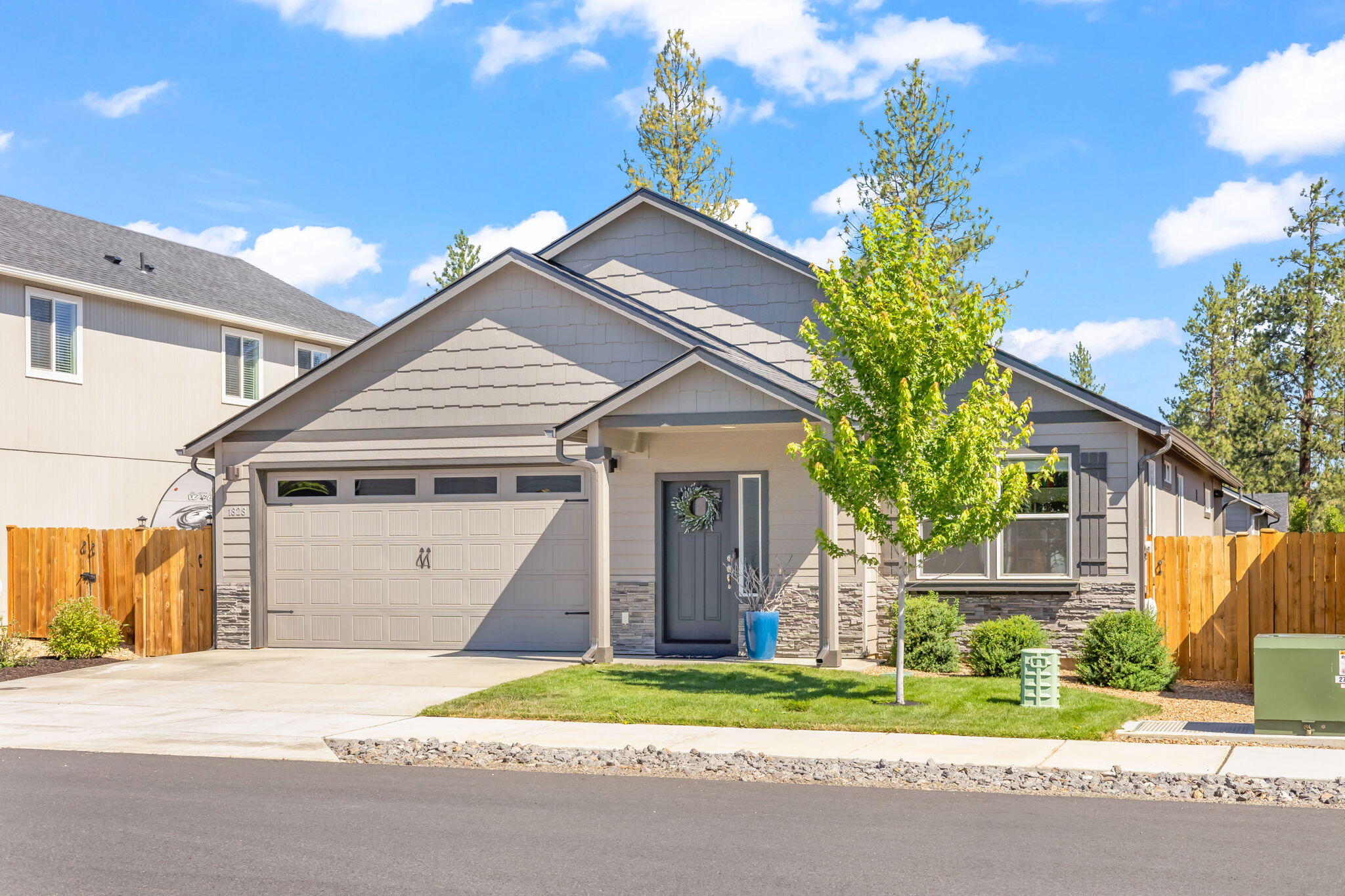 Welcome to this pristine 3-bedroom, 2-bathroom home in McKenzie Meadows Village. Completed in 2021 and impeccably maintained by its original owner, this residence boasts fresh exterior paint from 2024, offering a move-in-ready experience. The thoughtful layout includes an optional front-facing office, perfect for work or relaxation. The open living space flows into a modern kitchen, ideal for gatherings. Step outside to a beautifully landscaped backyard with a sprinkler system, a unique covered patio for year-round enjoyment, and a sliding glass door off the primary bedroom for private outdoor access. Just steps away lies a neighborhood park with a covered area, playground, and open lawn. Centrally located near all three Sisters District schools, national forest trails, walking paths, and the vibrant charm of downtown Sisters, this home is currently priced as the lowest  detached single-family property within Sisters.