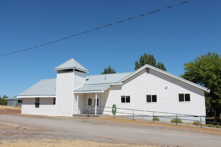 Your church in Bly, Oregon.  Once a bustling wood industry town,  now a slower paced community catering to the local ranchers, farmers and retired folks living gracefully among the pines and fresh air. The church has a large chapel with support offices.  The chapel has a large stage area. There are restrooms, a kitchen, a serving bar, a separate room for dining.  The exit doors are equipped with panic hardware. The church is equipped with three Mitsubishi air conditioner/heating units. The heating and A/C bills are less than a 100.00 dollars a month. There's plenty of parking available around the building.  Located between Klamath Falls and Lakeview, this is a must see. Church is tax exempt. Taxes may change with new owner.