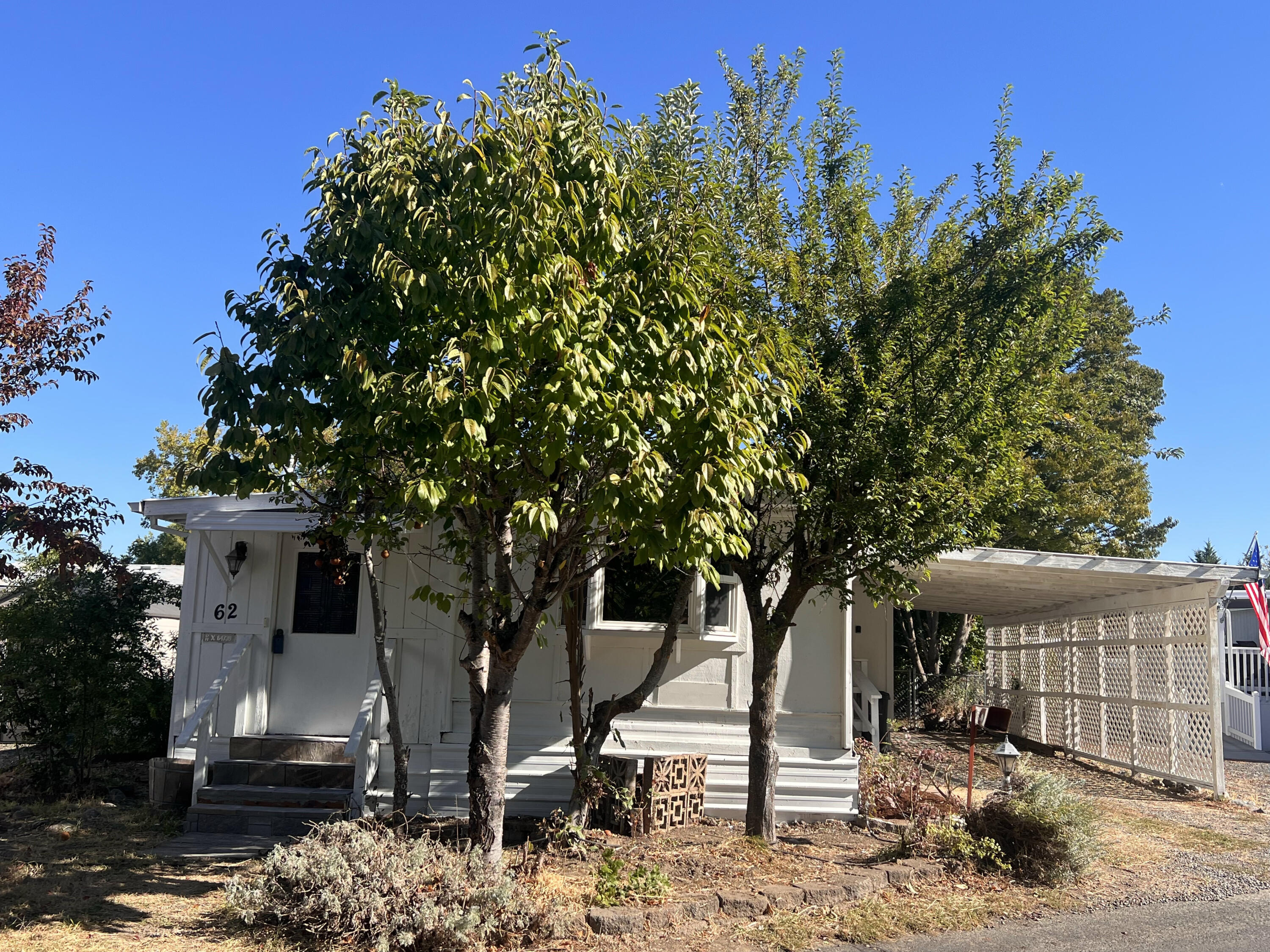 Charming & affordable home in a desirable 55+ park with some of the lowest space rent around! Freshly painted & cleaned, this 2 bed/1 bath includes 2 bonus additions—an entryway w/ French door office or craft room & a convenient laundry room w/ washer & dryer. All appliances included! Enjoy fruit trees, storage shed, covered parking & views of Redwood Park. Centrally located near shopping, dining & medical facilities. Move-in ready!