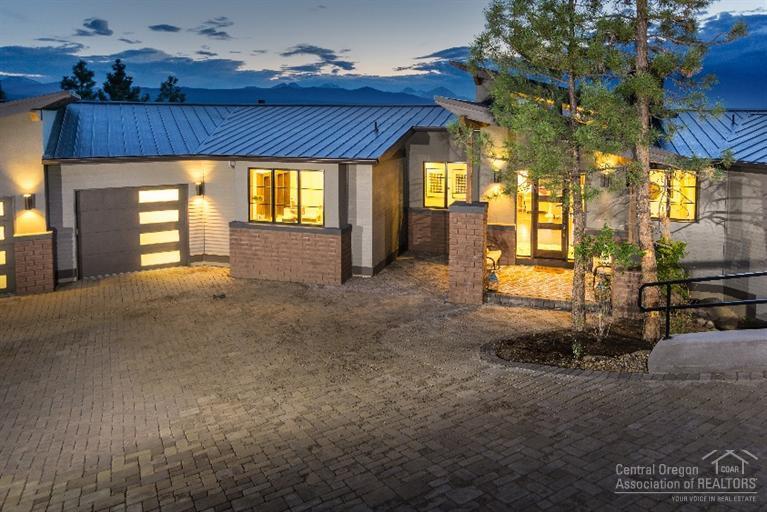 New Pricing on this custom RD Building & Design home which boasts full Cascade Mountain views! 2014 COBA Tour winner. Superb finishes & planning of this residence brings elegant contemporary design features to an Awbrey Butte setting. A 16 ft. patio door brings the outside inside, which exposes the beauty to the interior spaces. This home features an over-sized 3 car garage, landscaped lot, heated paver driveway, lower level paver patio, wood windows, exercise room, media room, wine tasting room and more